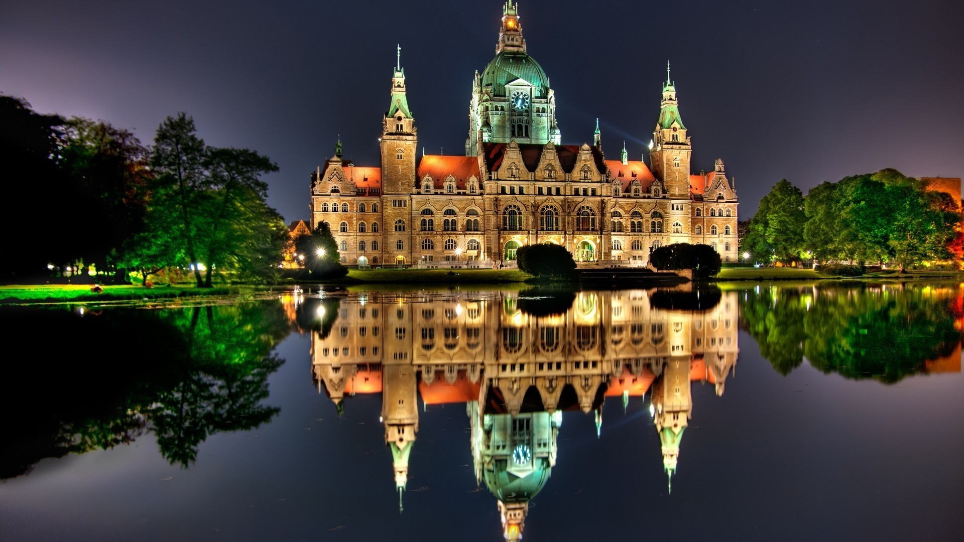 New City Hall building reflected in water at night HD Wallpaper