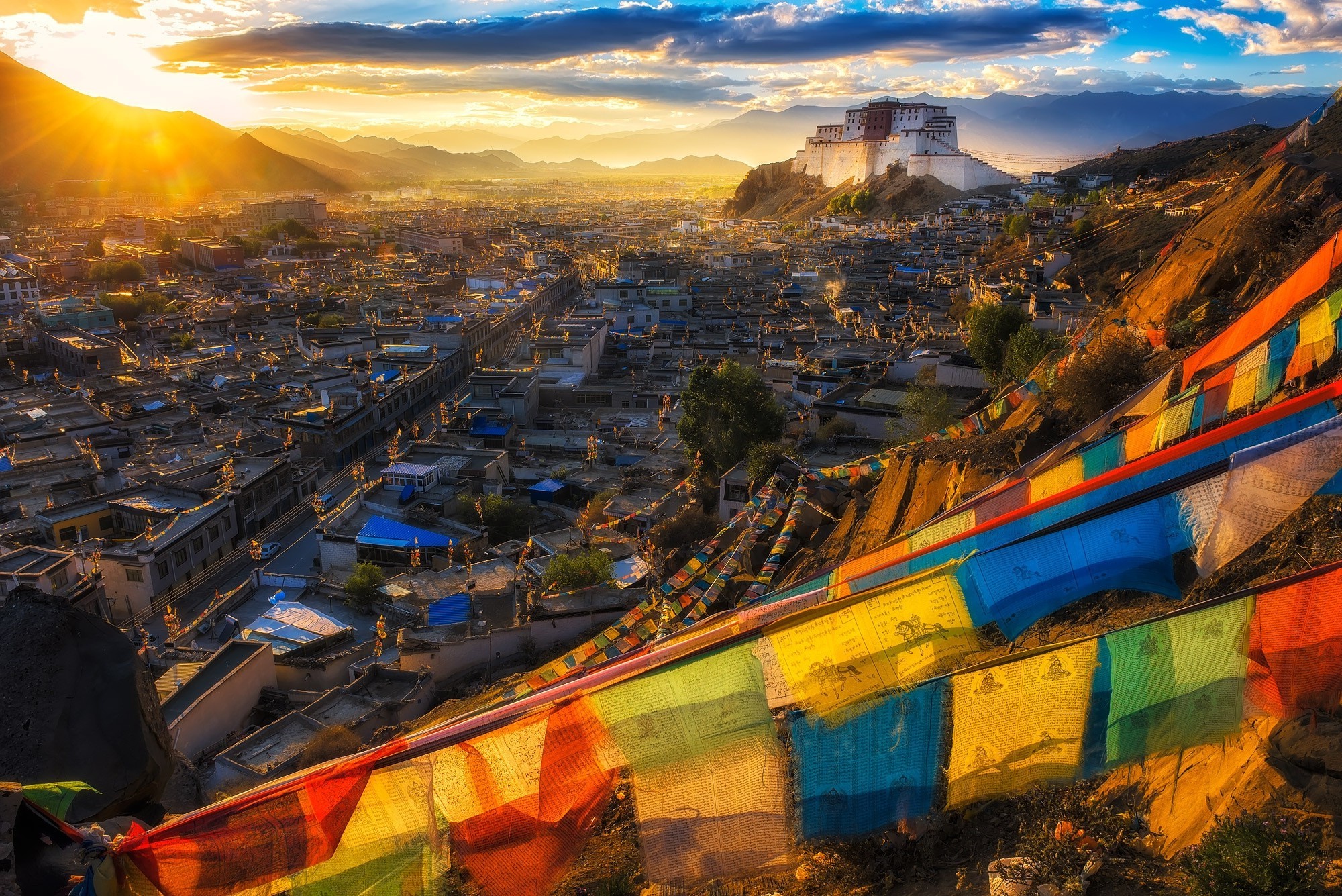 Potala Palace in Lhasa, Tibet at sunset with prayer flags HD Wallpaper