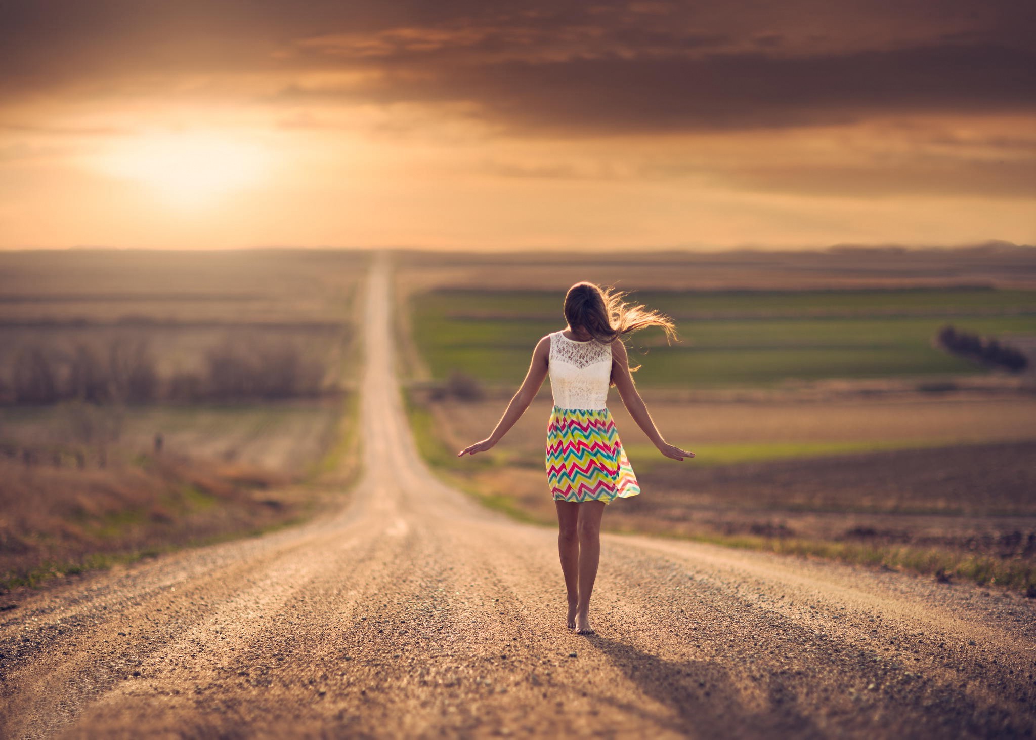 Woman walking on a road in Nebraska at sunset HD Wallpaper