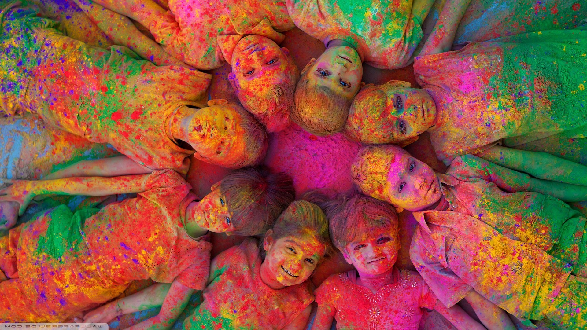 Children covered in colorful powder during Holi festival HD Wallpaper