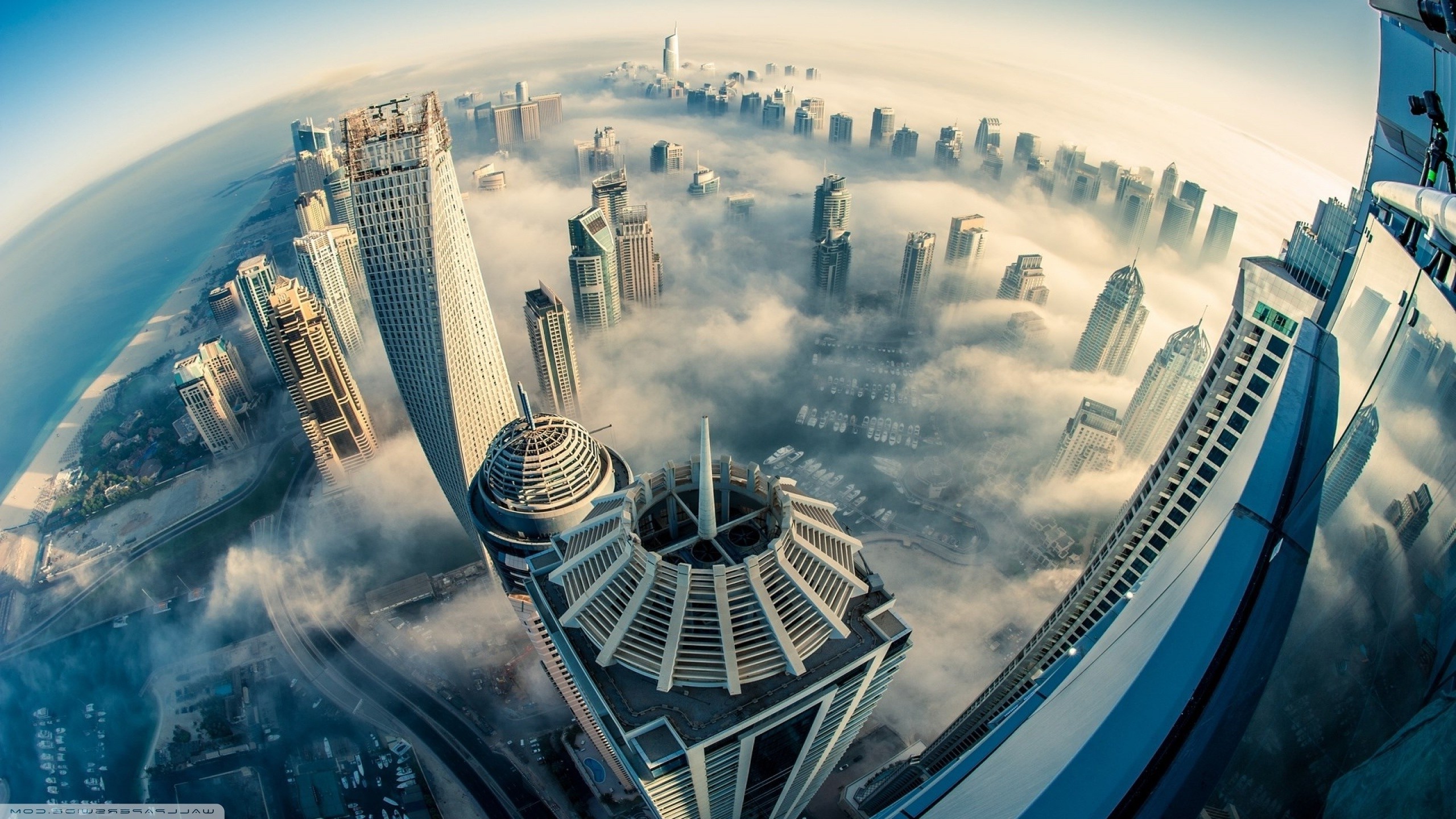 Dubai cityscape aerial view through clouds with fisheye lens HD Wallpaper