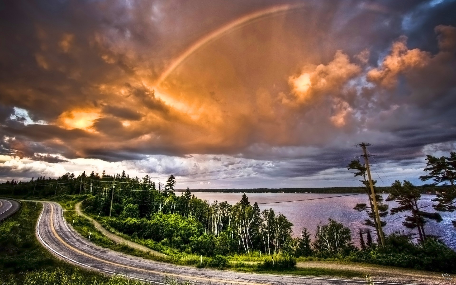Rainbow over a lake and road HD Wallpaper