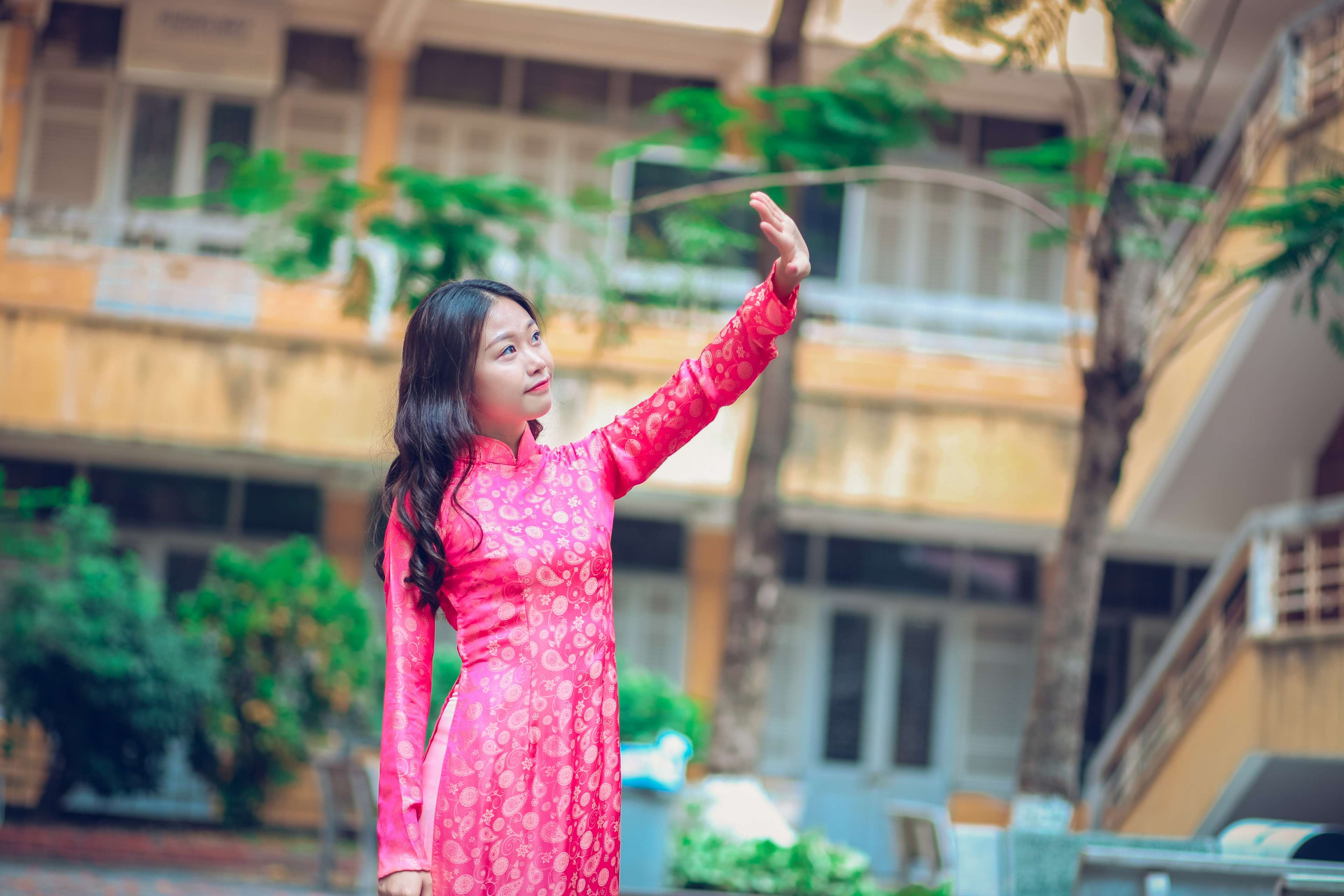 Young woman in pink dress posing outdoors HD Wallpaper