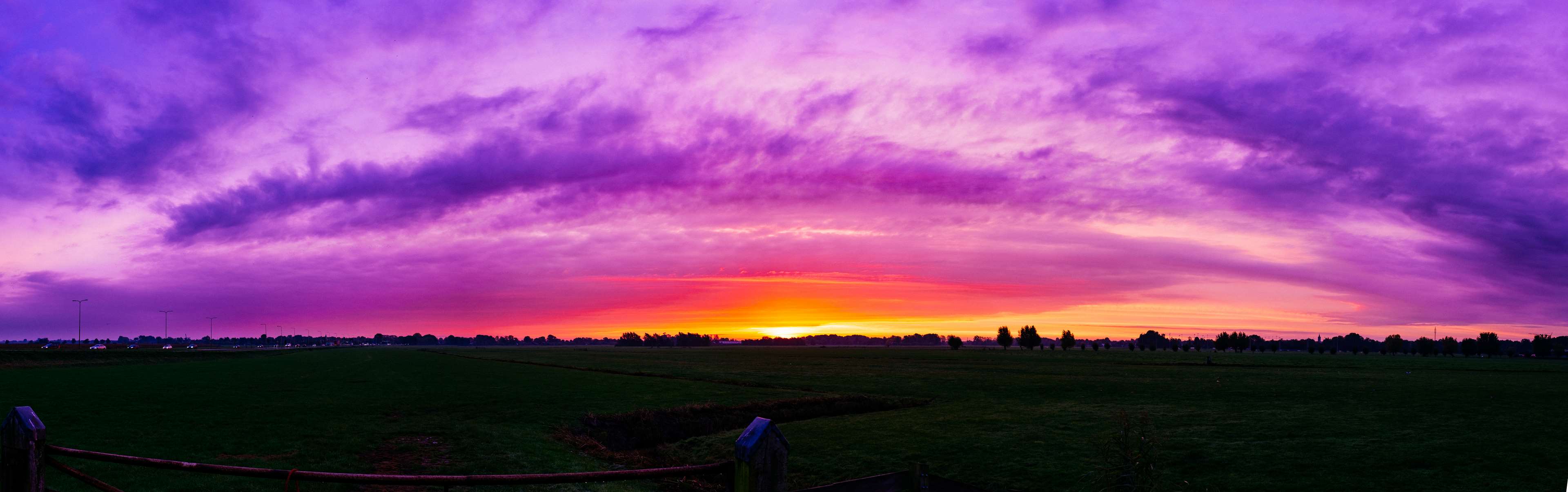 Panoramic sunset over a field HD Wallpaper