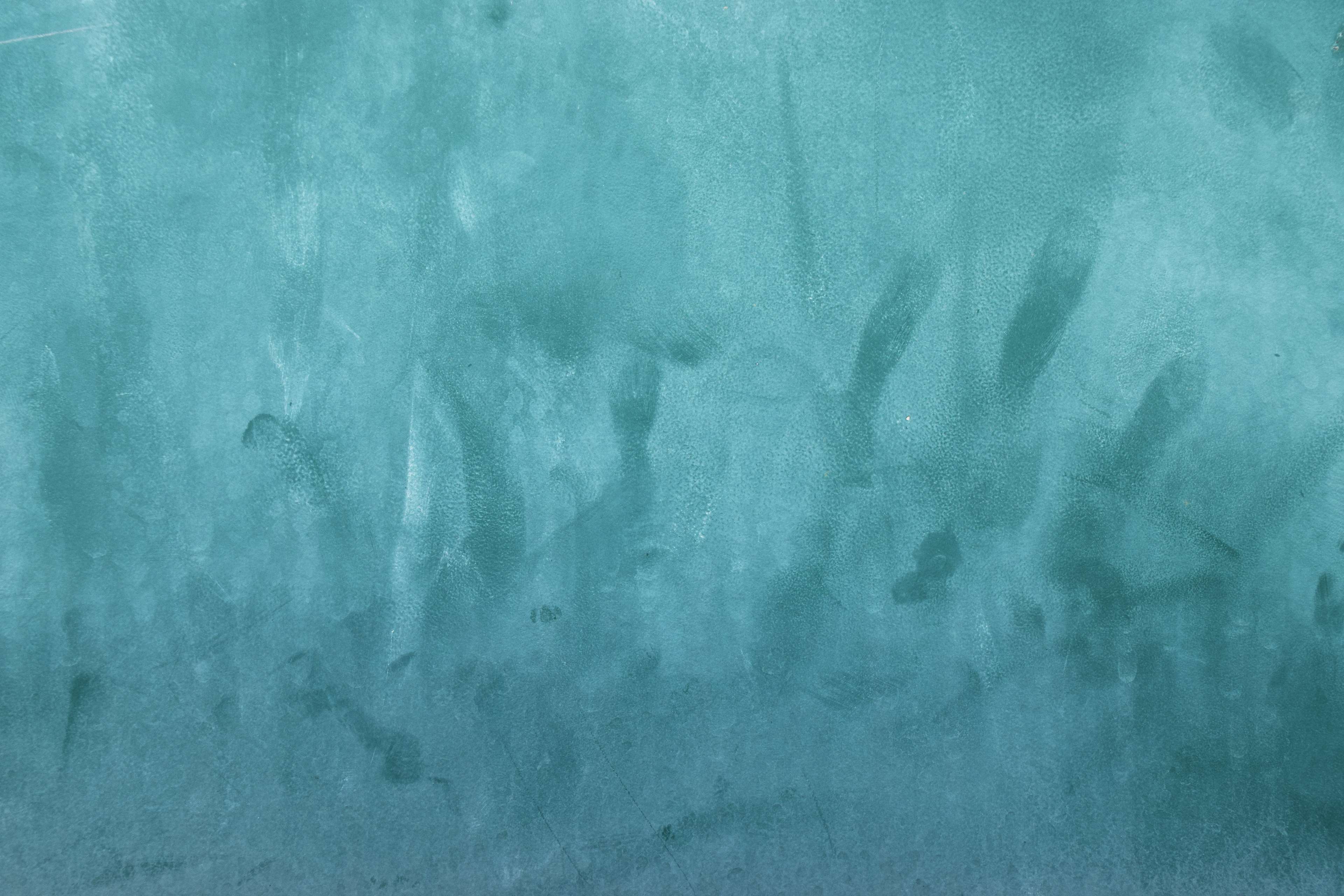 Aqua blue textured surface with smudges and handprints HD Wallpaper