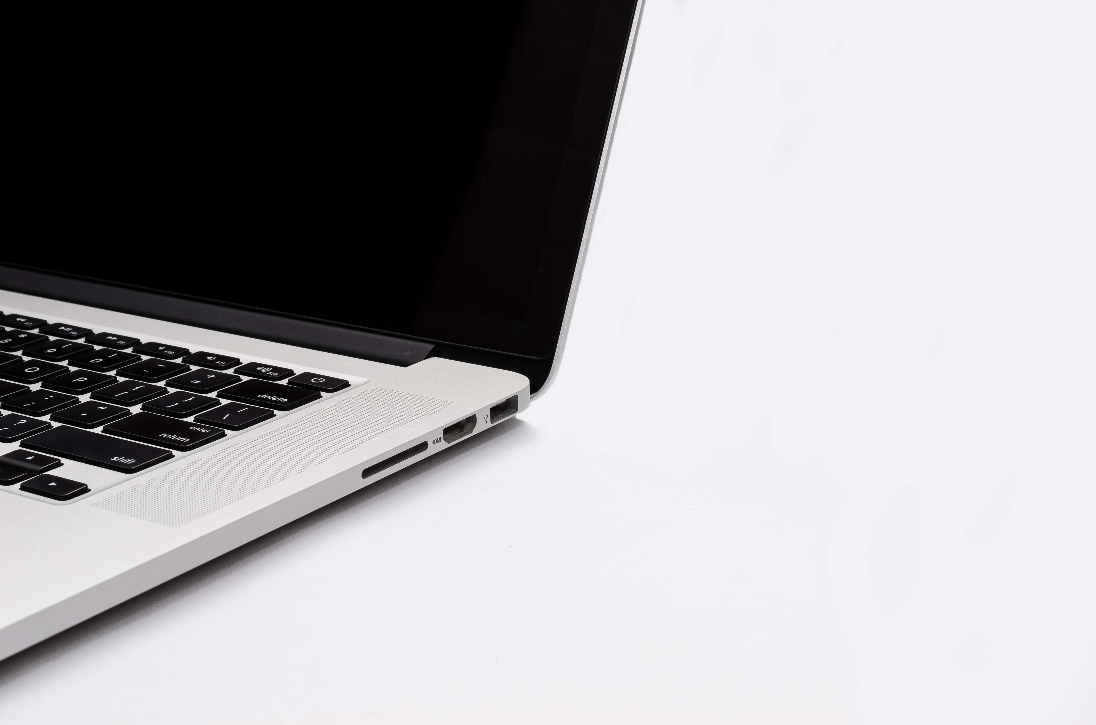 Close-up of a silver MacBook laptop with a black screen and keyboard HD Wallpaper