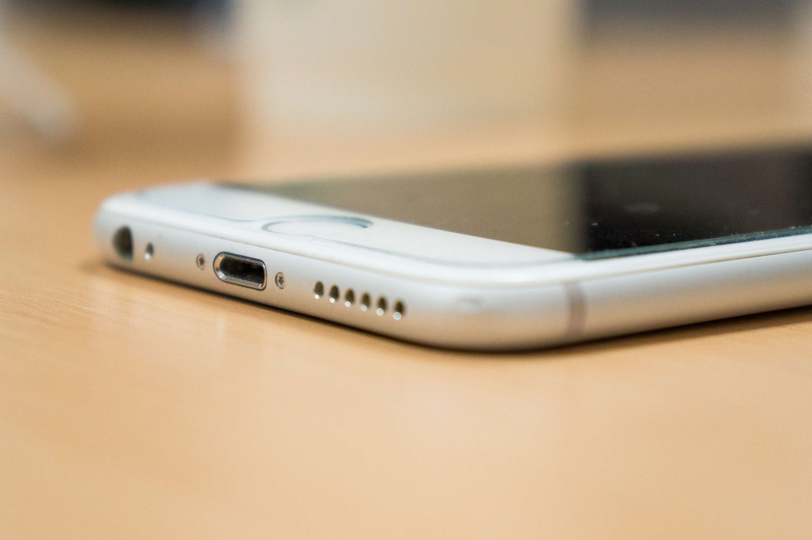Close-up of an iPhone's charging port and speaker grill HD Wallpaper