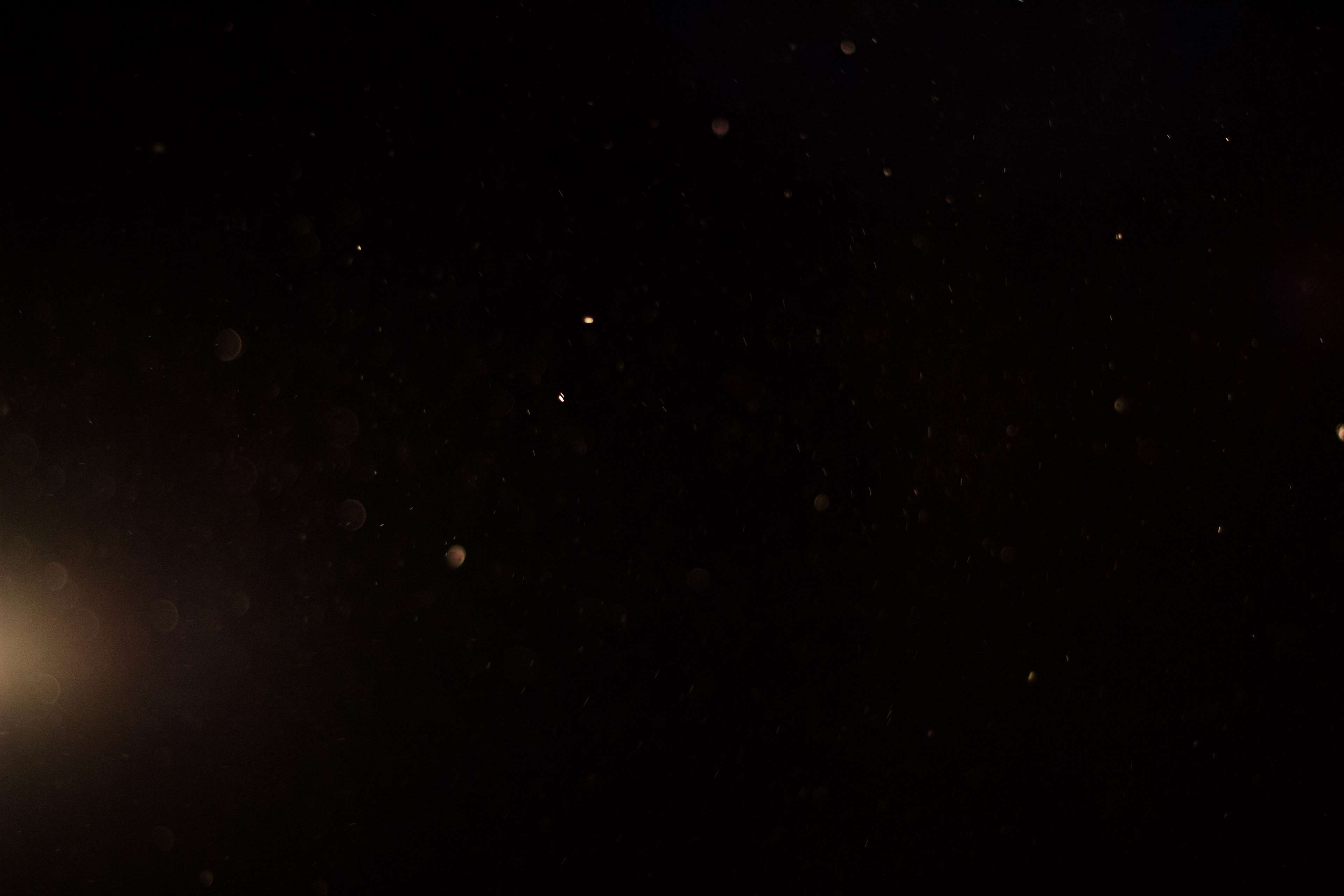 Dust particles in dark space with glow HD Wallpaper