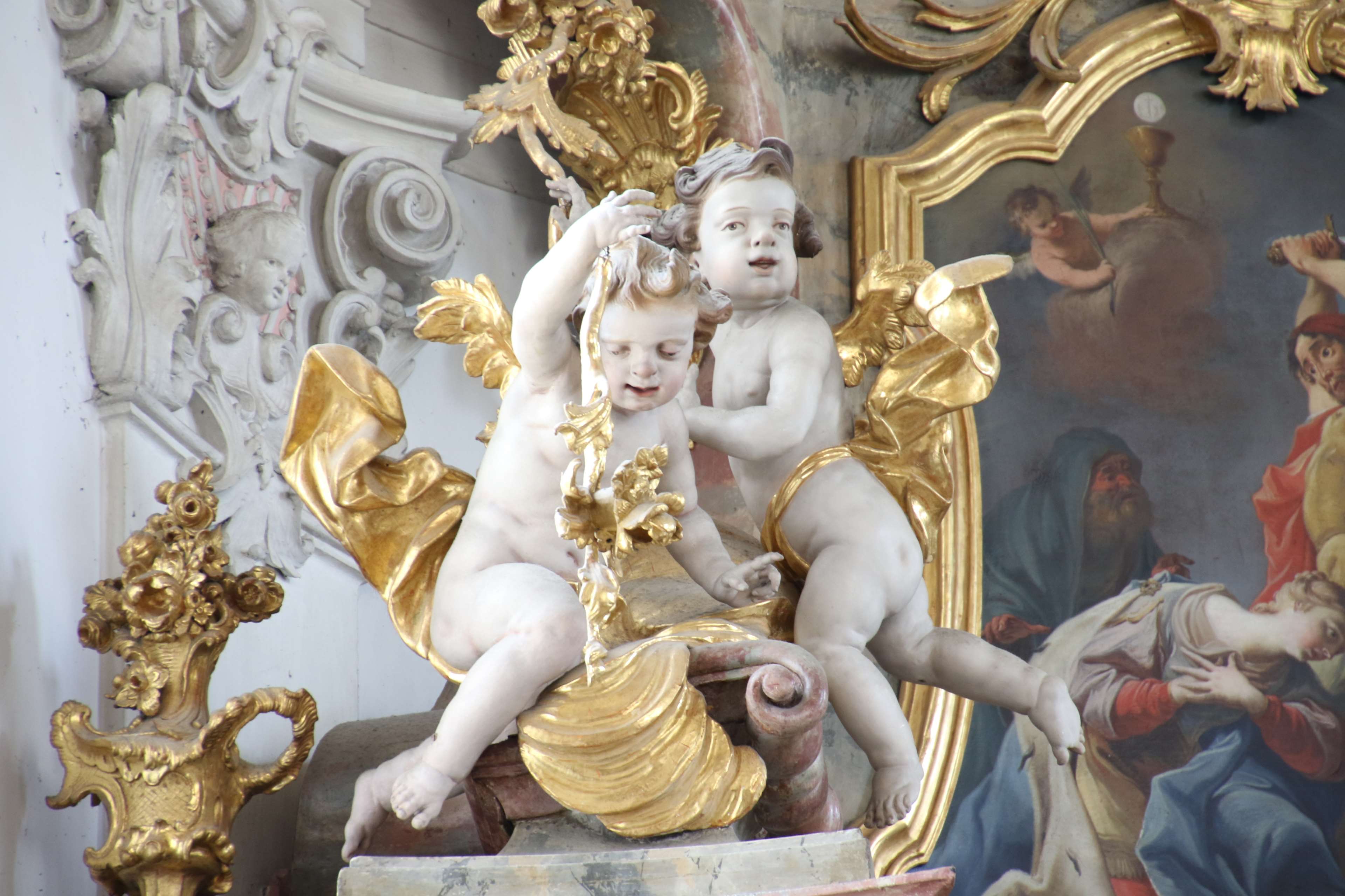 Marble cherubs with golden decorations in a church HD Wallpaper