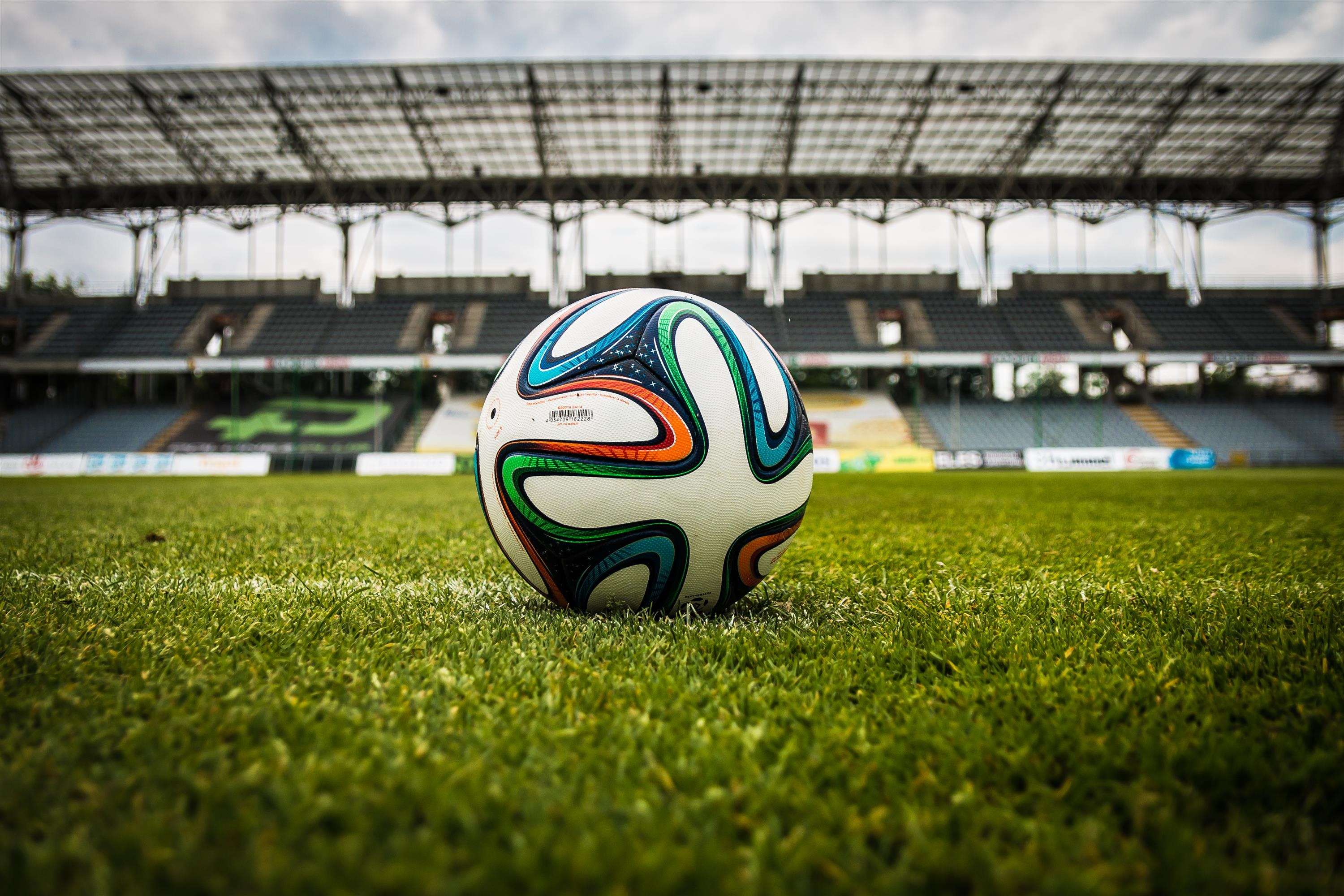 Soccer ball on a stadium field HD Wallpaper