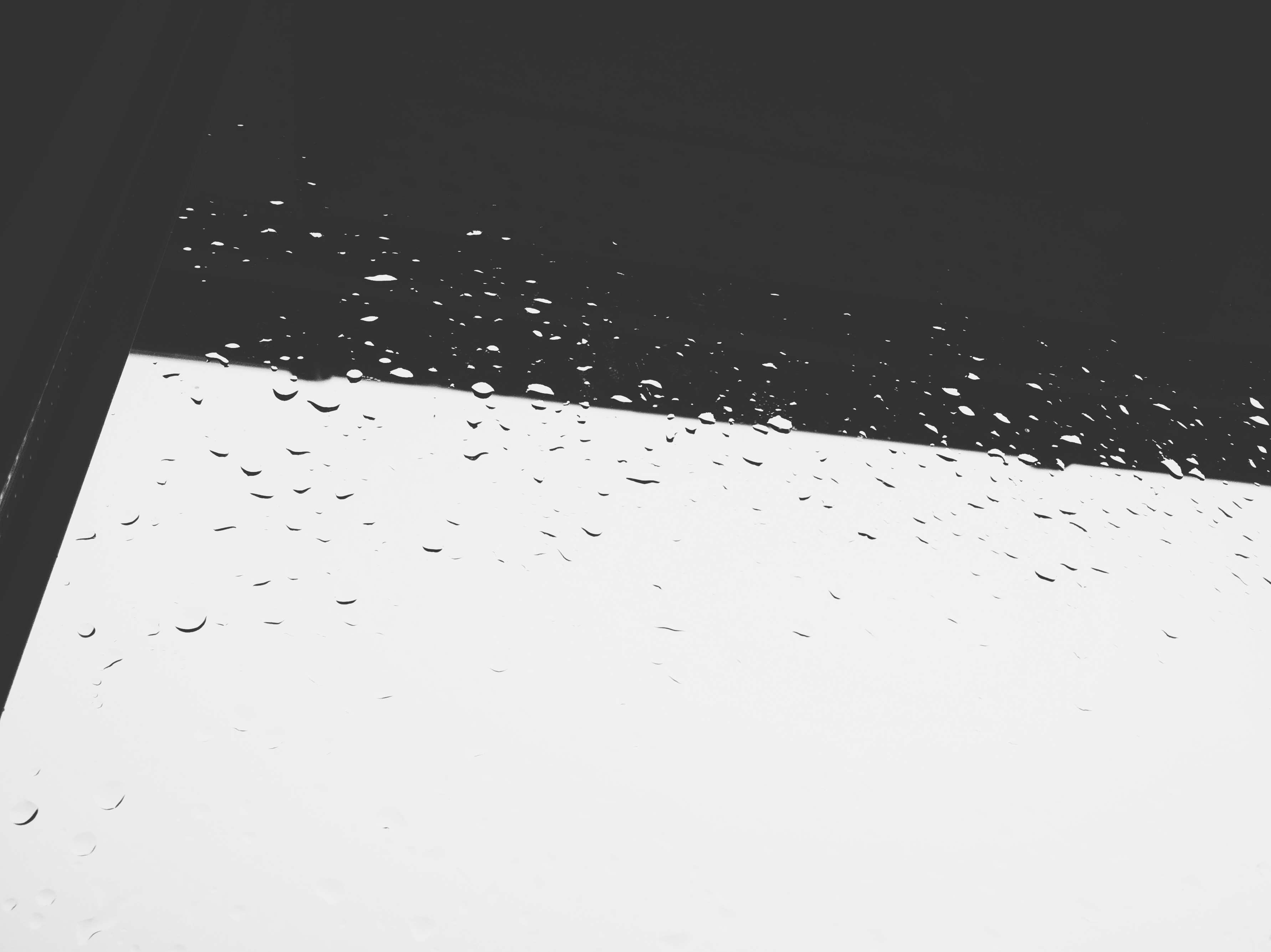 Raindrops on a window with dark shadow HD Wallpaper