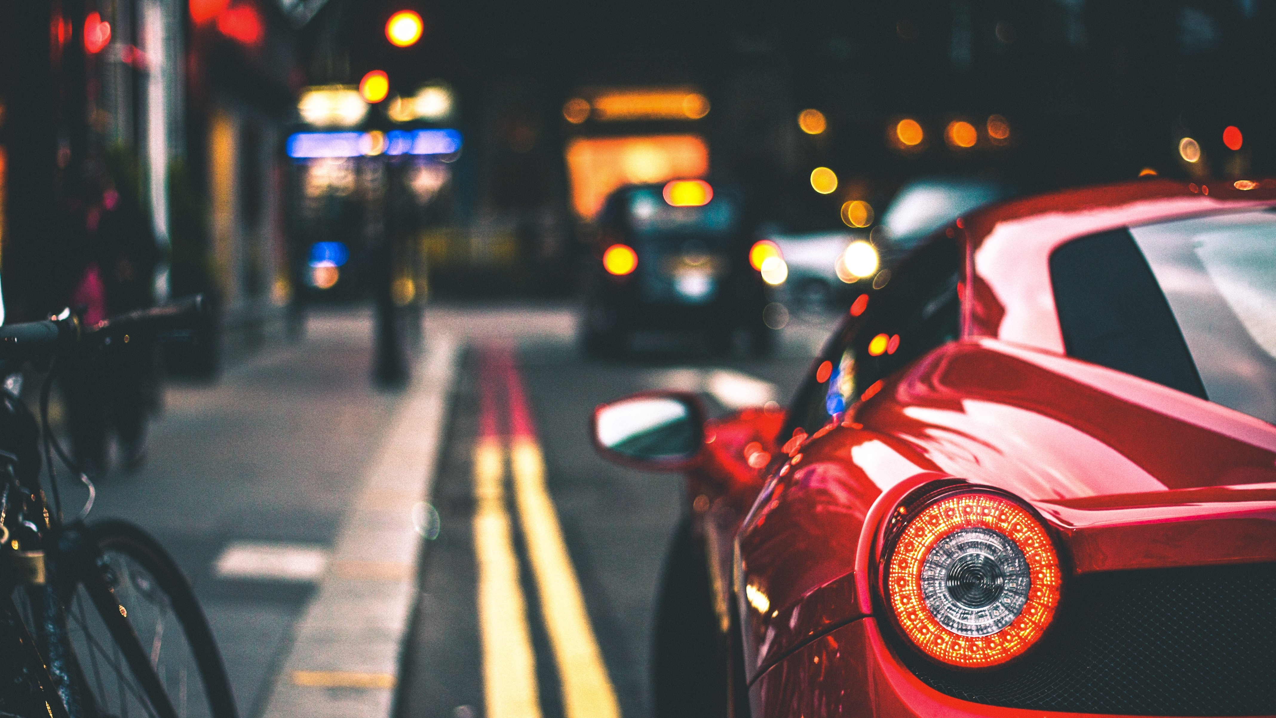 Red sports car on a city street at night HD Wallpaper