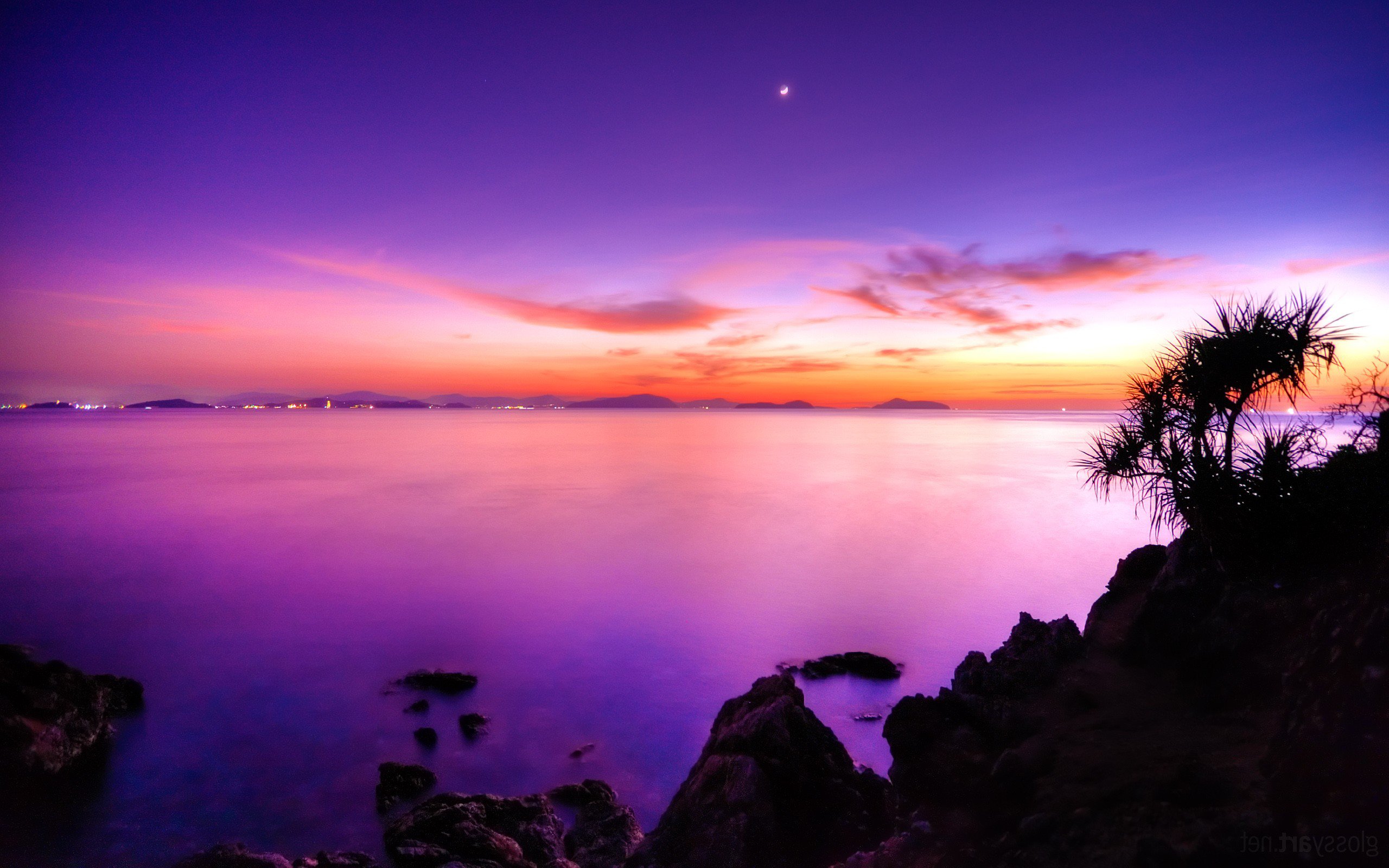 Purple and pink sunset over the ocean with rocky shore HD Wallpaper