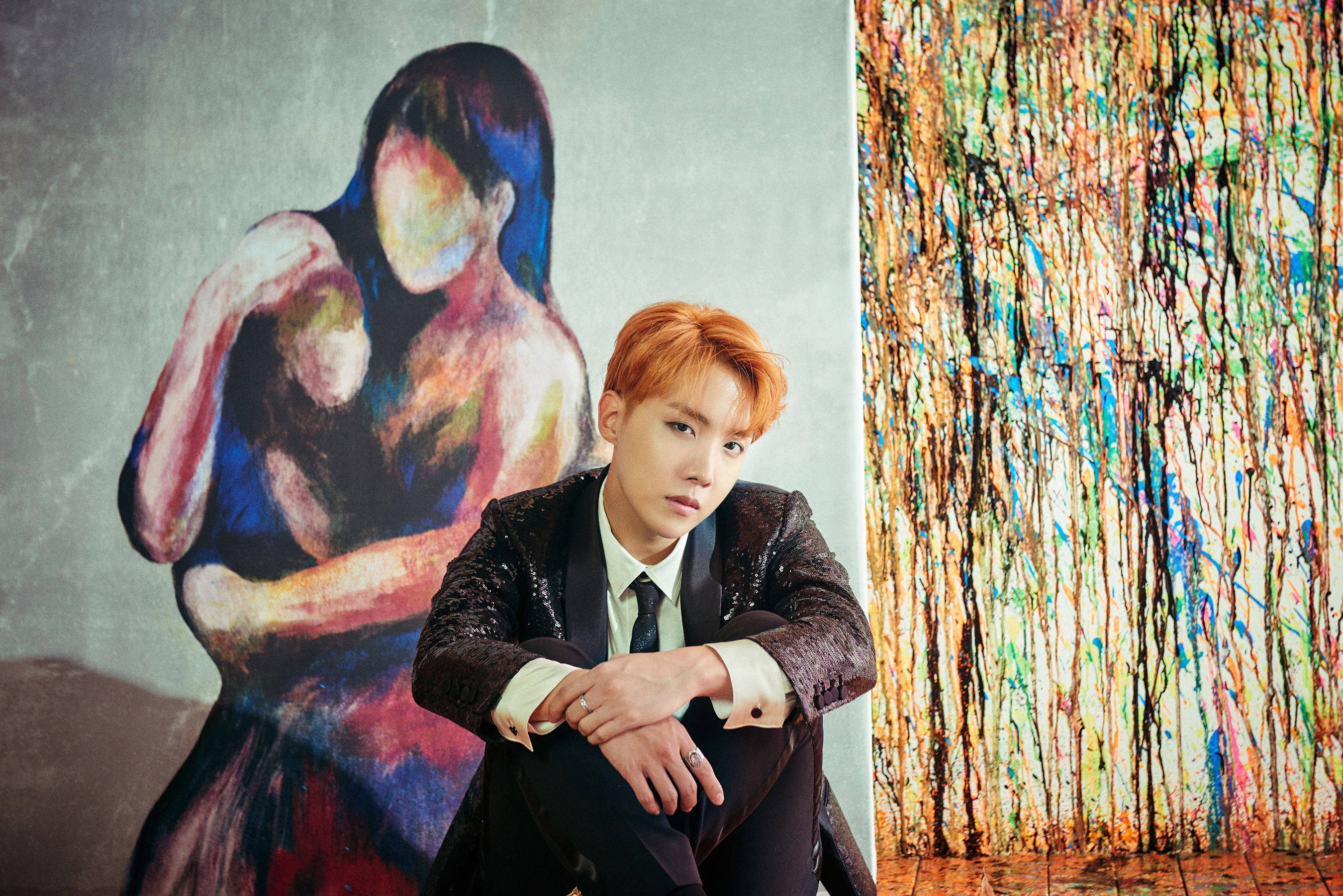 J-Hope from BTS sitting in front of paintings HD Wallpaper