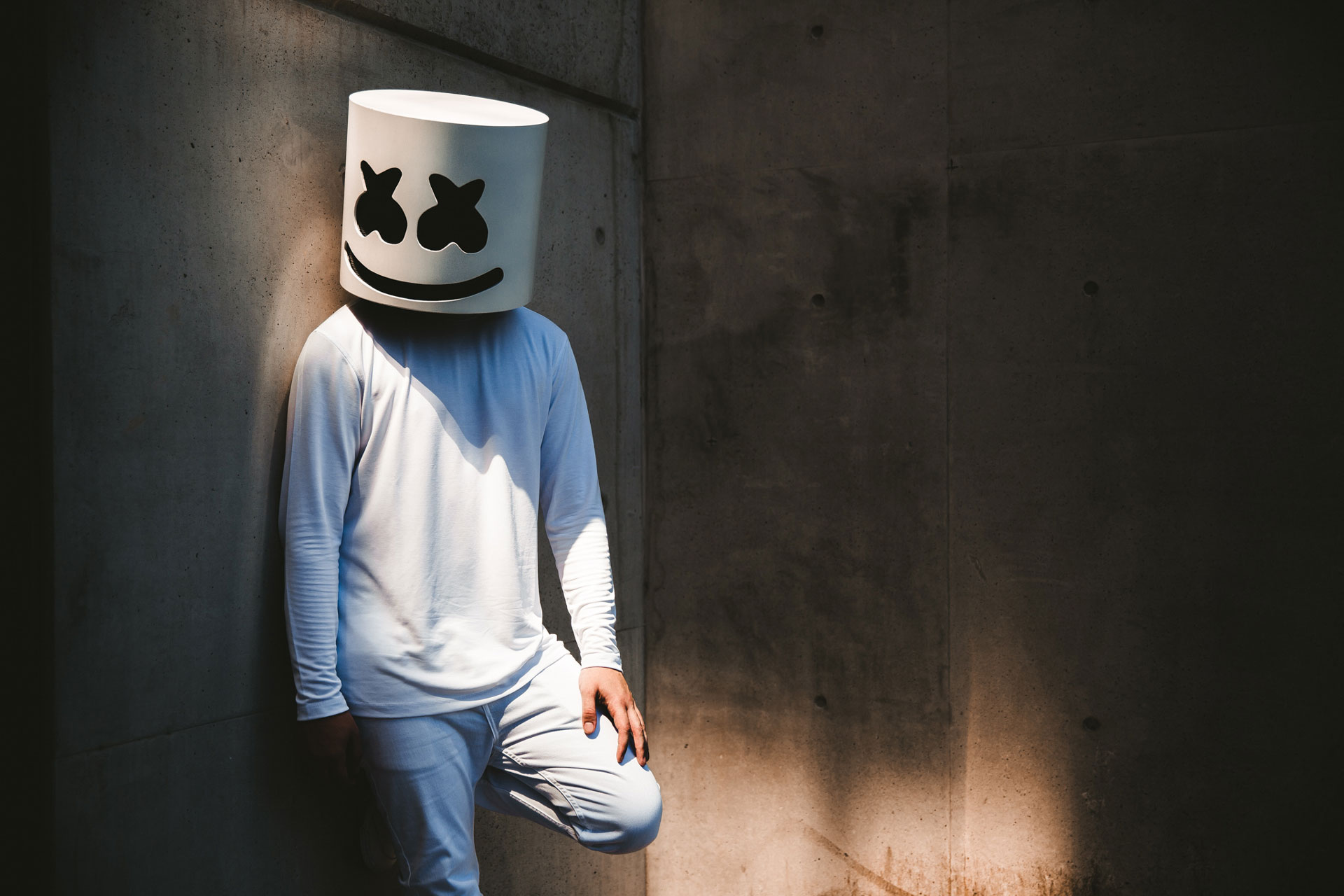 Marshmello leaning against a concrete wall HD Wallpaper