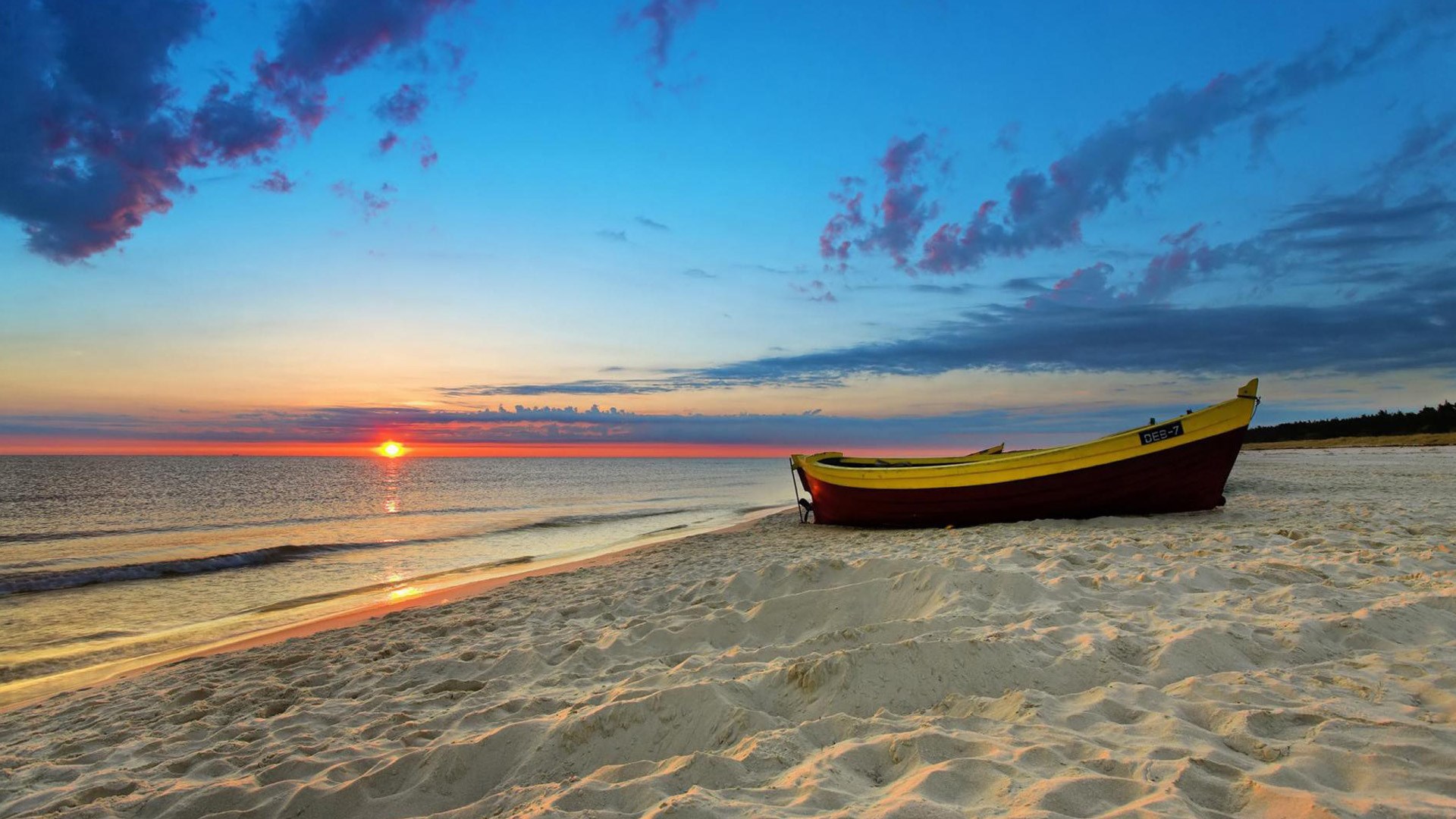 Boat on a sandy beach at sunset HD Wallpaper