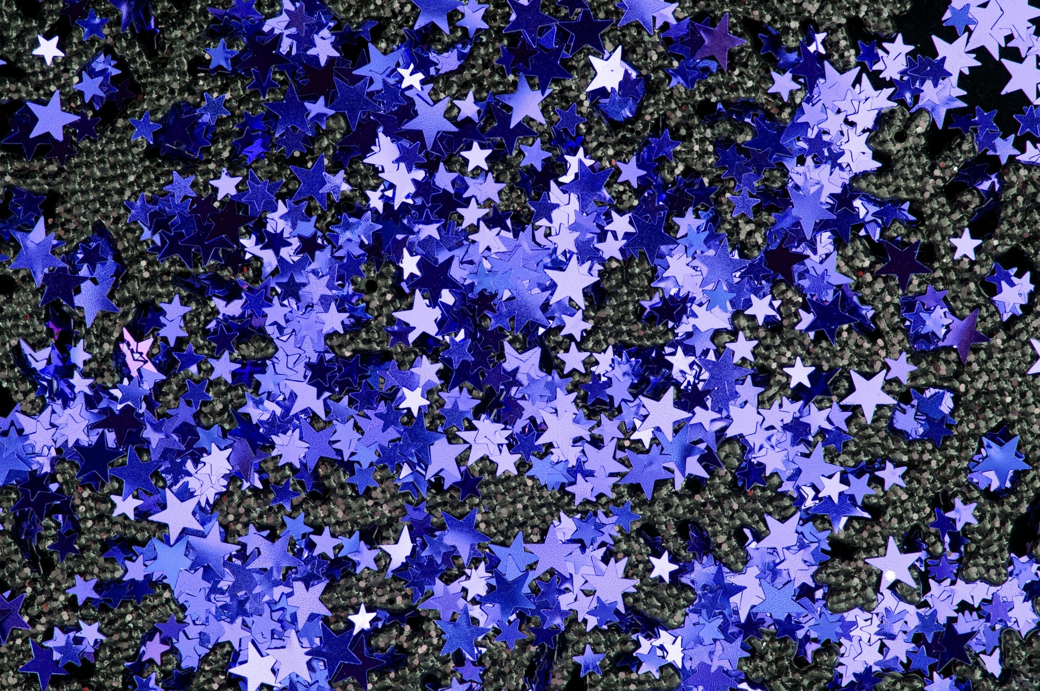 Blue star confetti on a dark textured surface HD Wallpaper