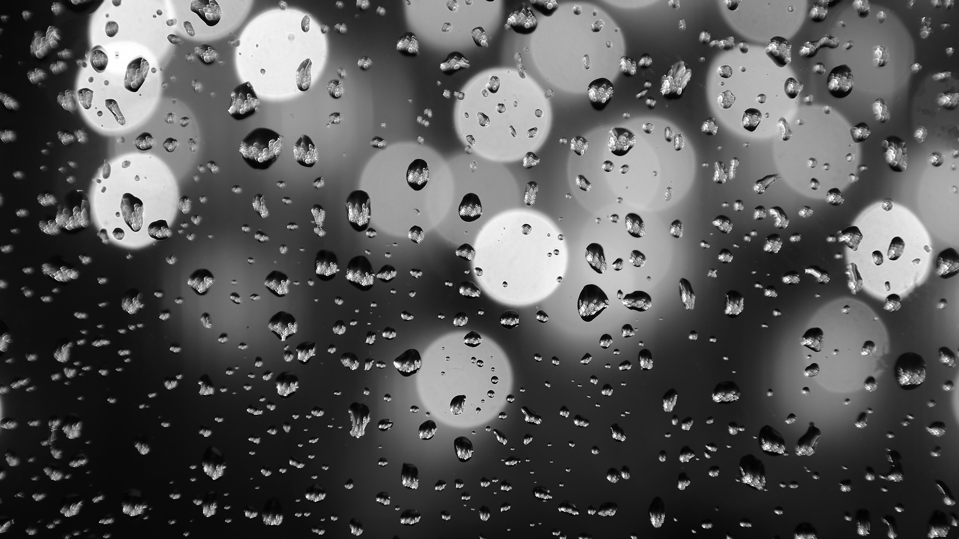 Raindrops on glass with bokeh lights HD Wallpaper