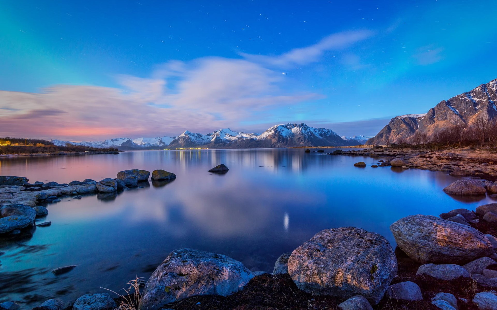 Snowy mountains reflected in a calm lake at twilight HD Wallpaper