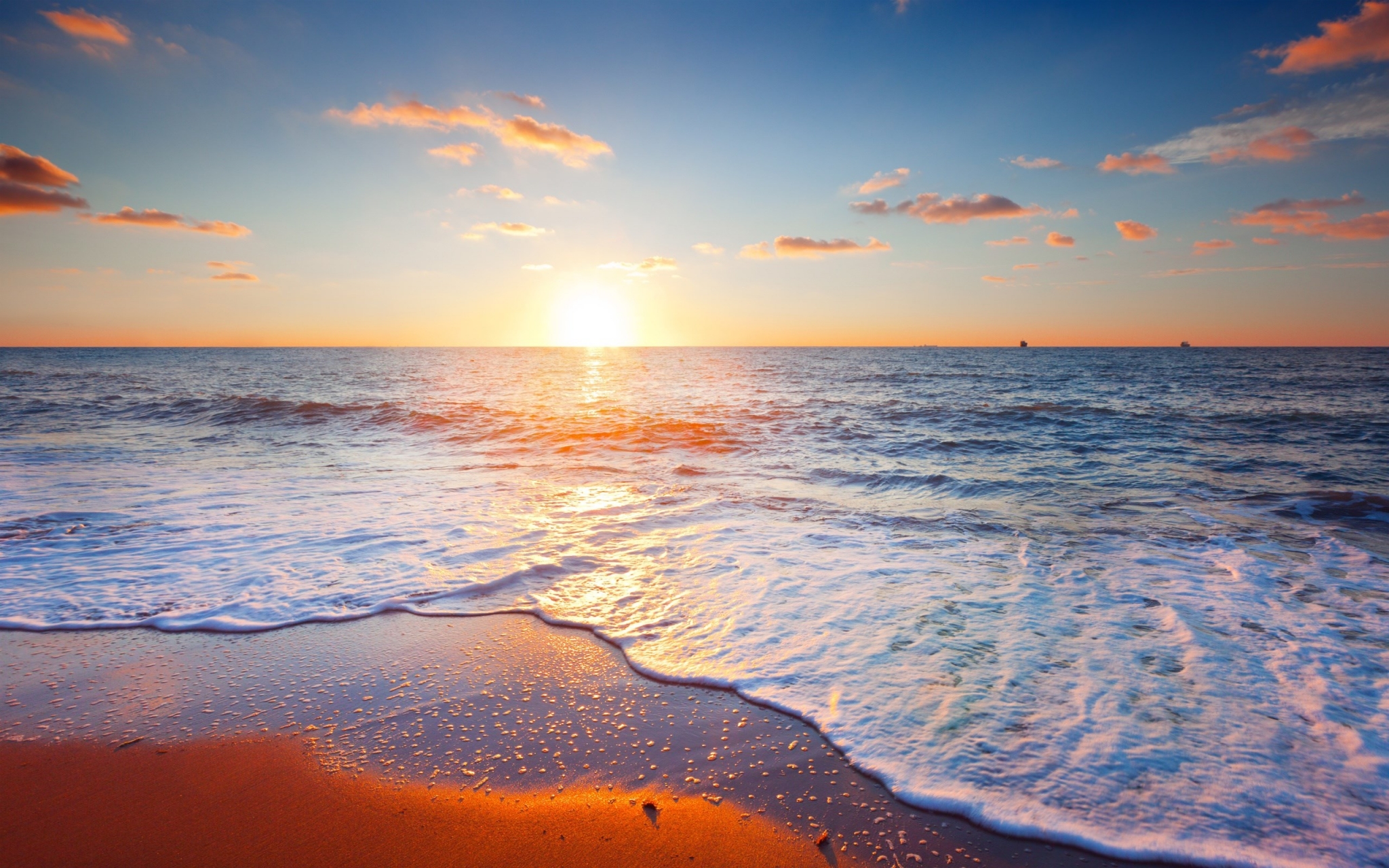 Sunset over the ocean with waves on the beach HD Wallpaper