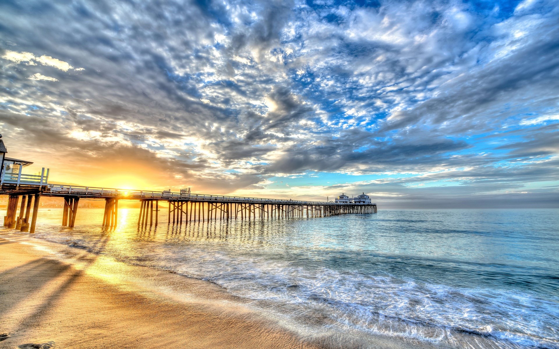 Pier over the ocean at sunset with dramatic clouds HD Wallpaper