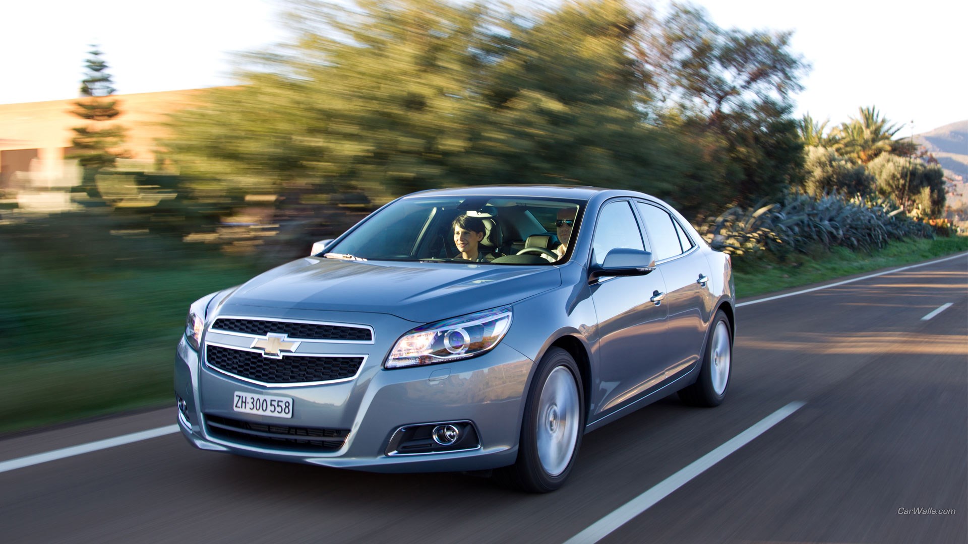 Chevrolet Malibu driving on a road HD Wallpaper