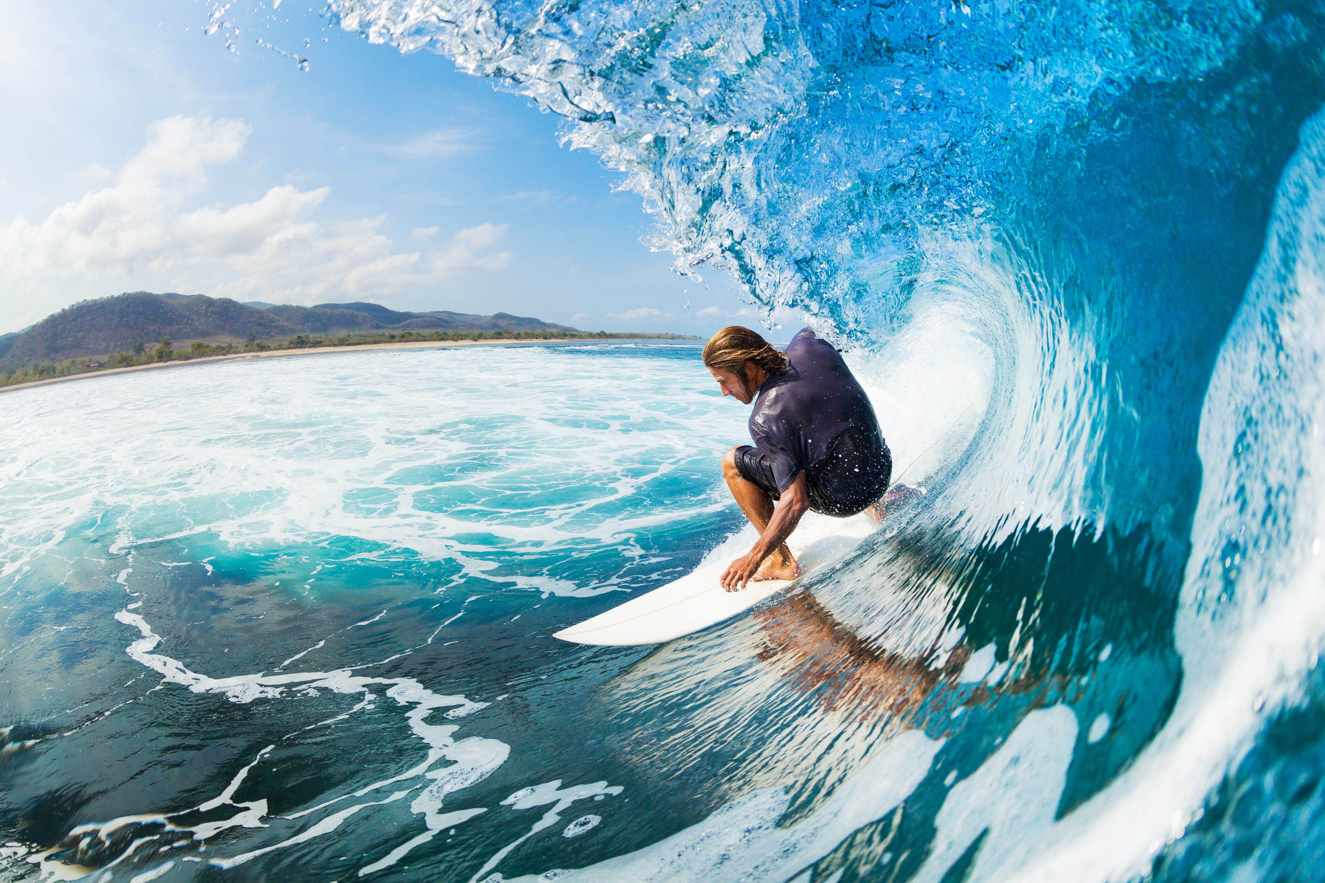 Surfer riding a wave inside a barrel HD Wallpaper