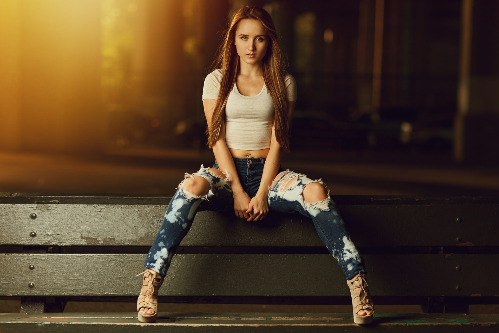 Young Woman Sitting on Bench in Urban Setting HD Wallpaper