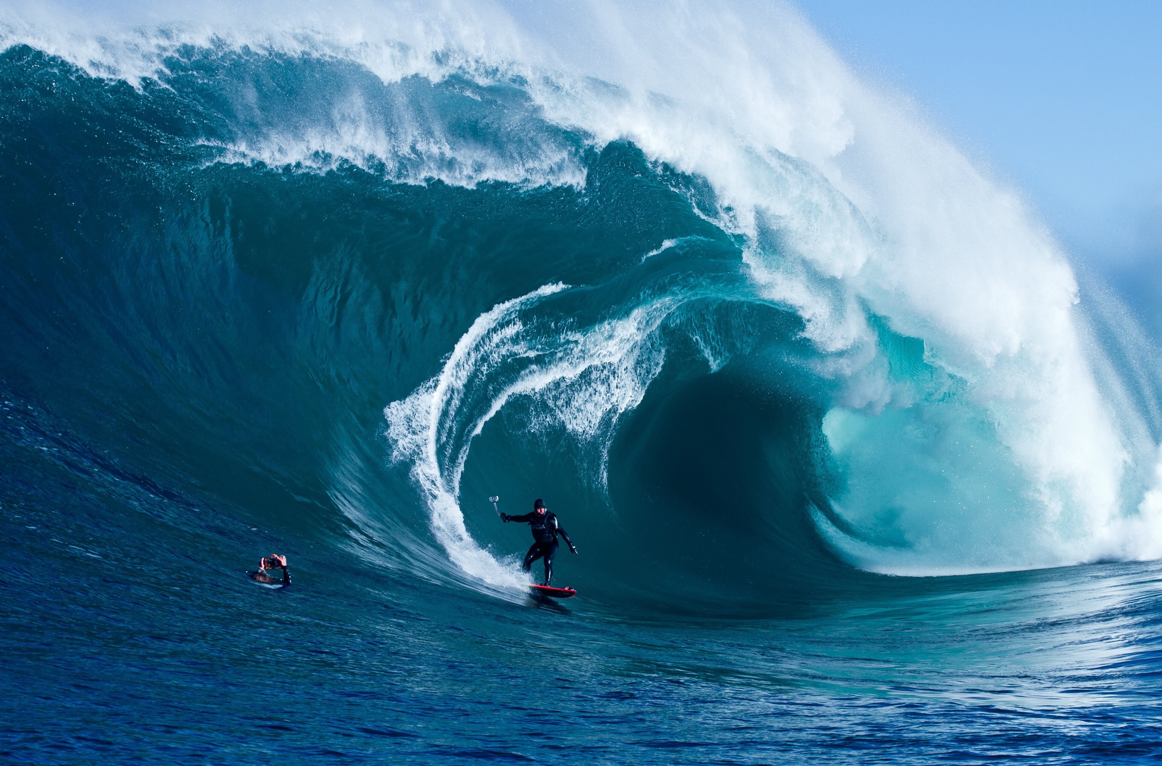 Surfer riding a giant wave in 4K HD Wallpaper