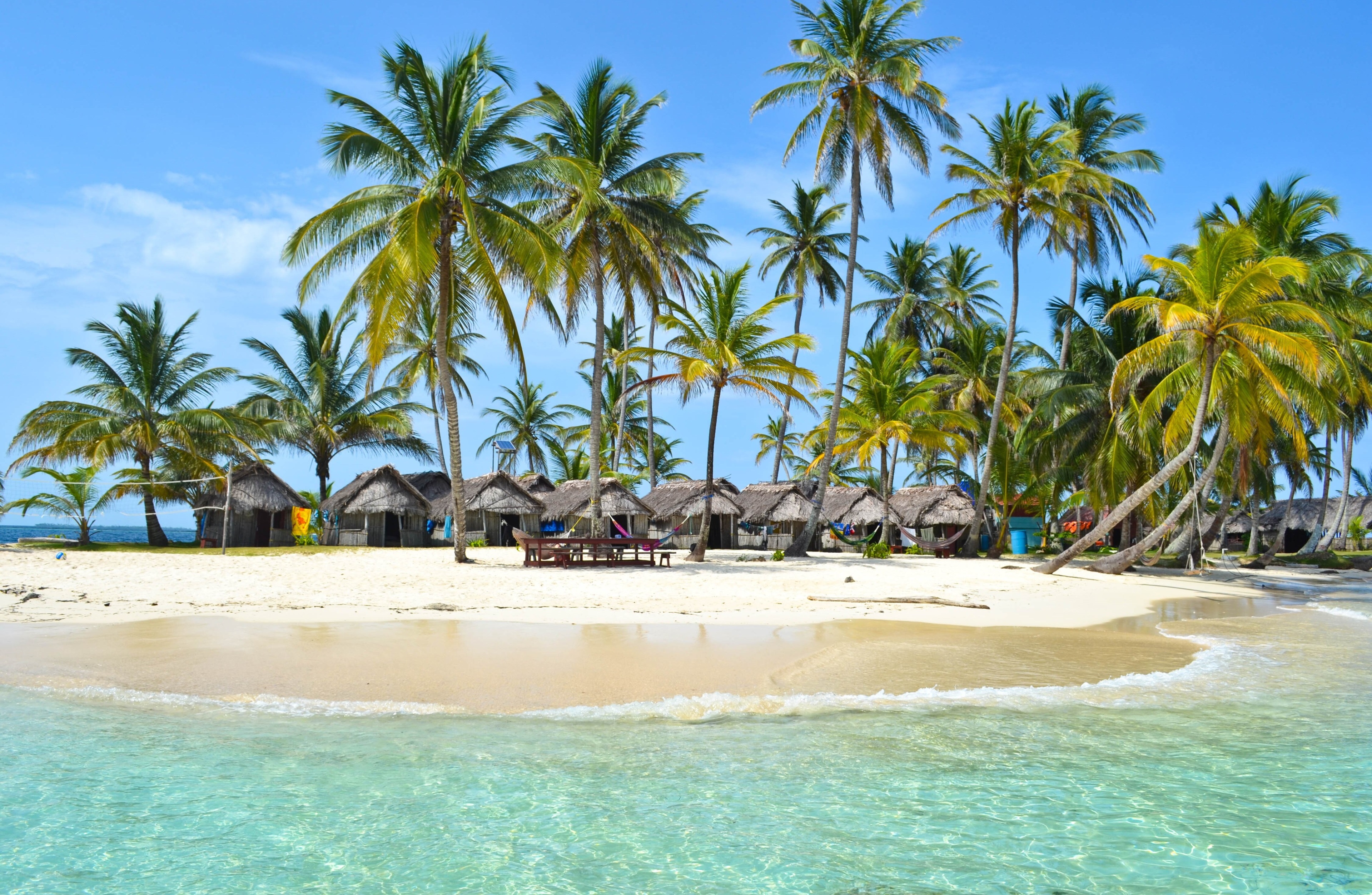 Tropical island with palm trees and huts HD Wallpaper