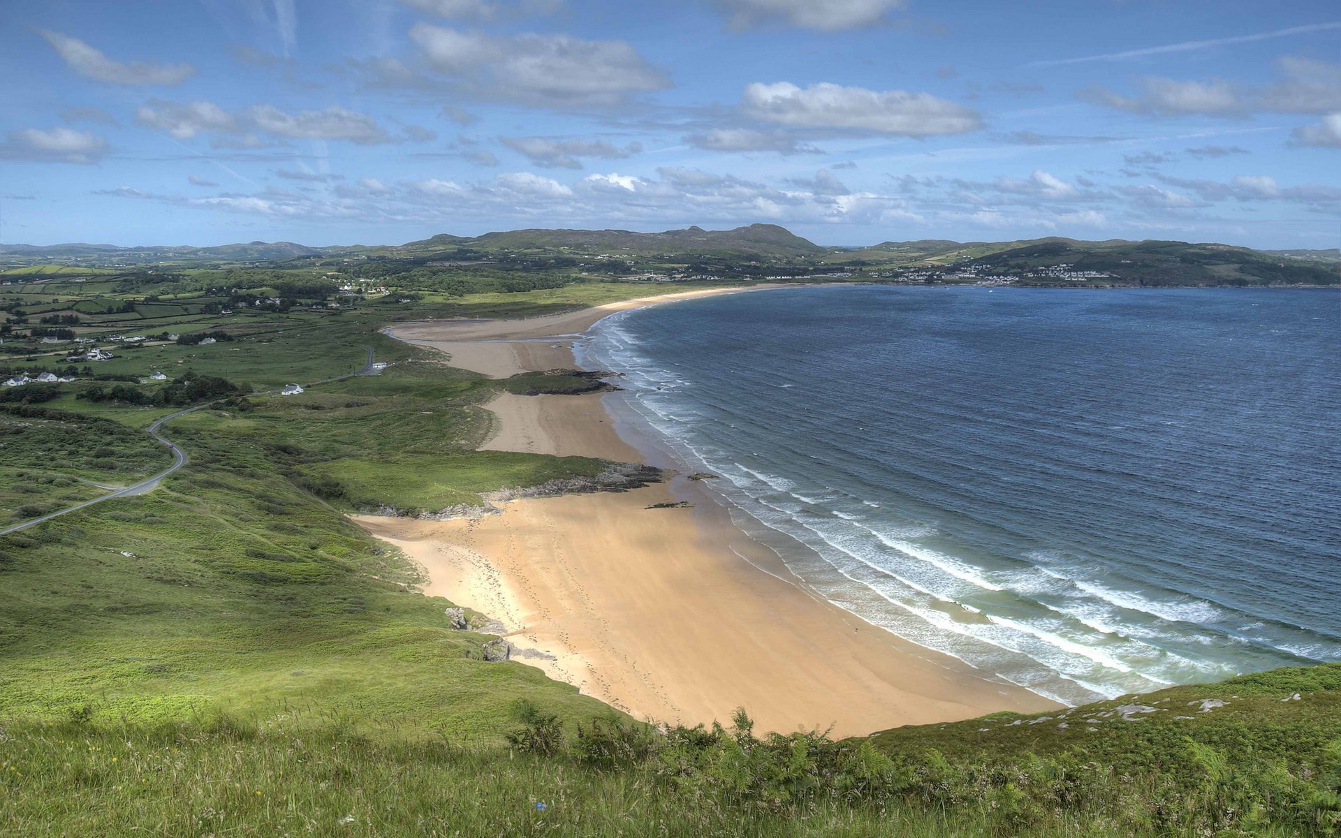 Coastal landscape with a sandy beach and blue ocean HD Wallpaper