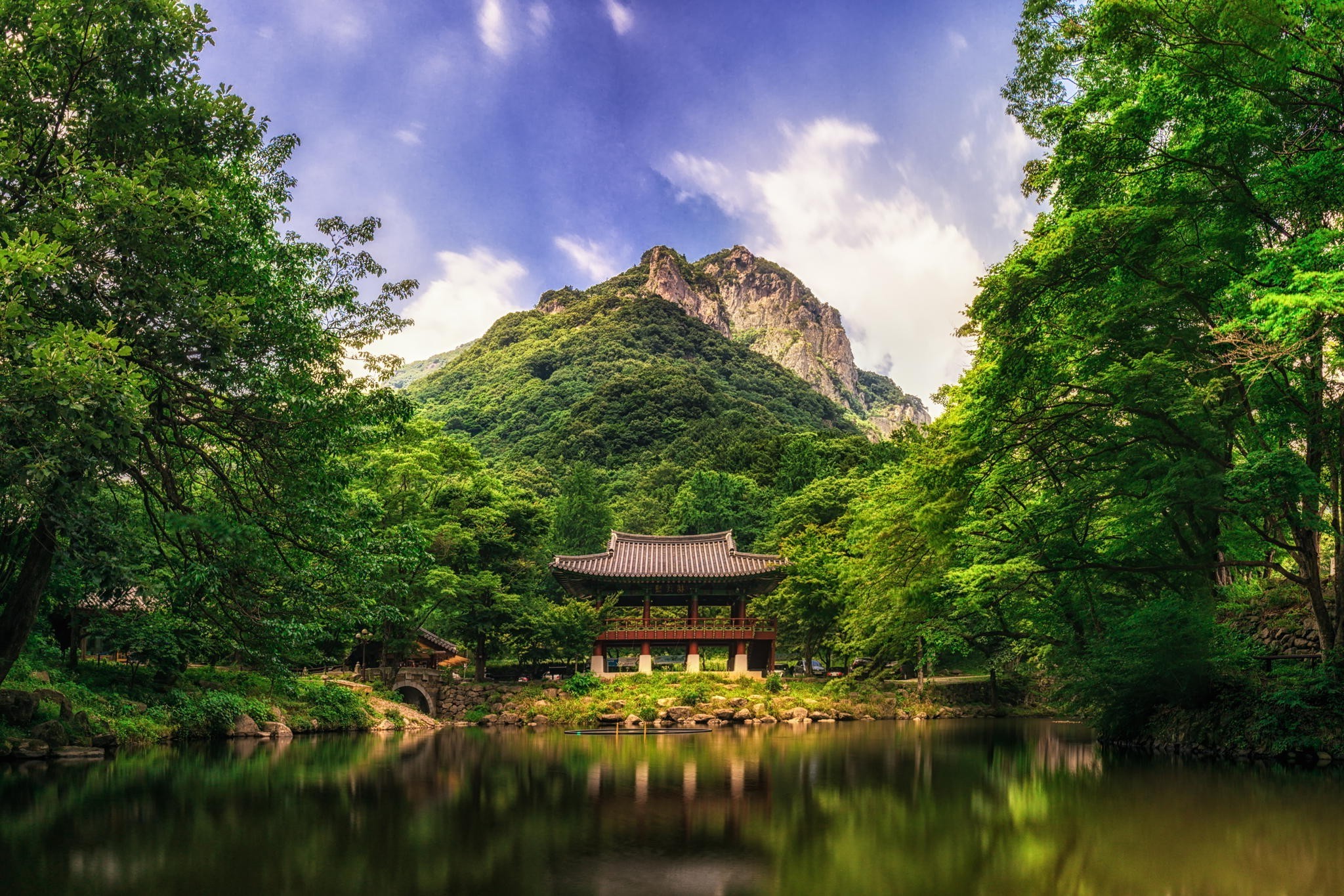 Traditional Korean pavilion by a lake with a mountain backdrop HD Wallpaper
