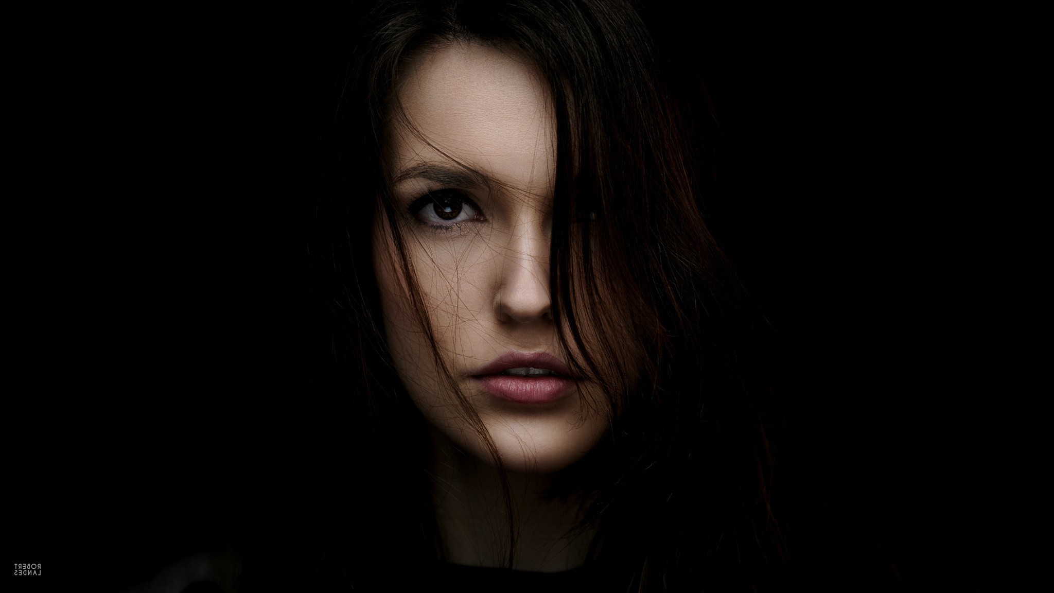 Woman's face with hair covering part of her face HD Wallpaper