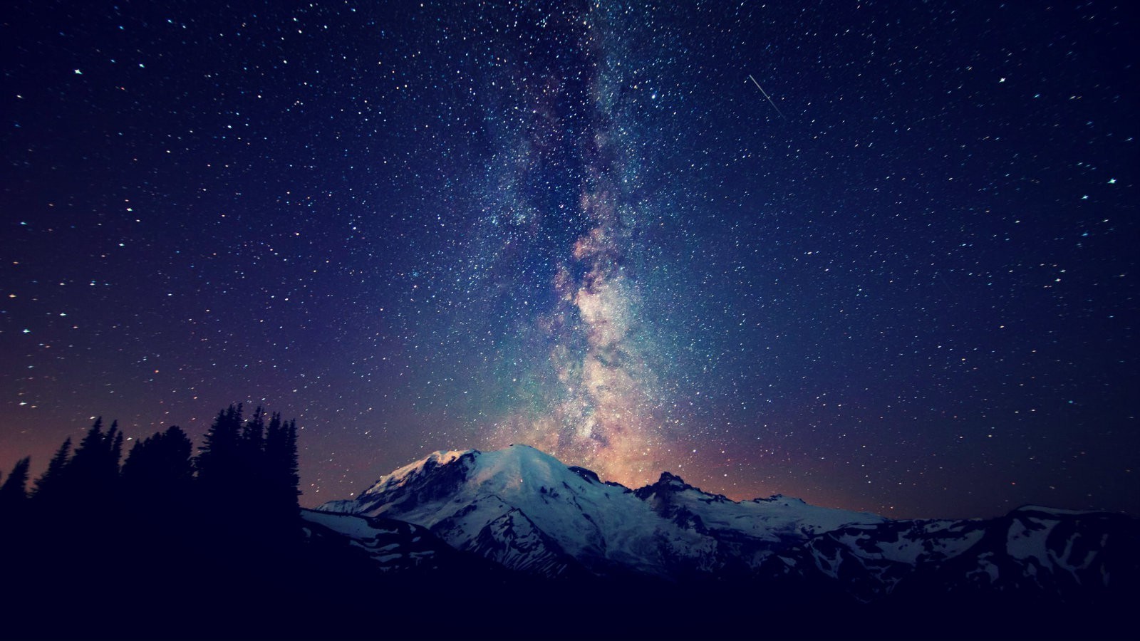 Milky Way over snow-capped mountains and pine trees HD Wallpaper