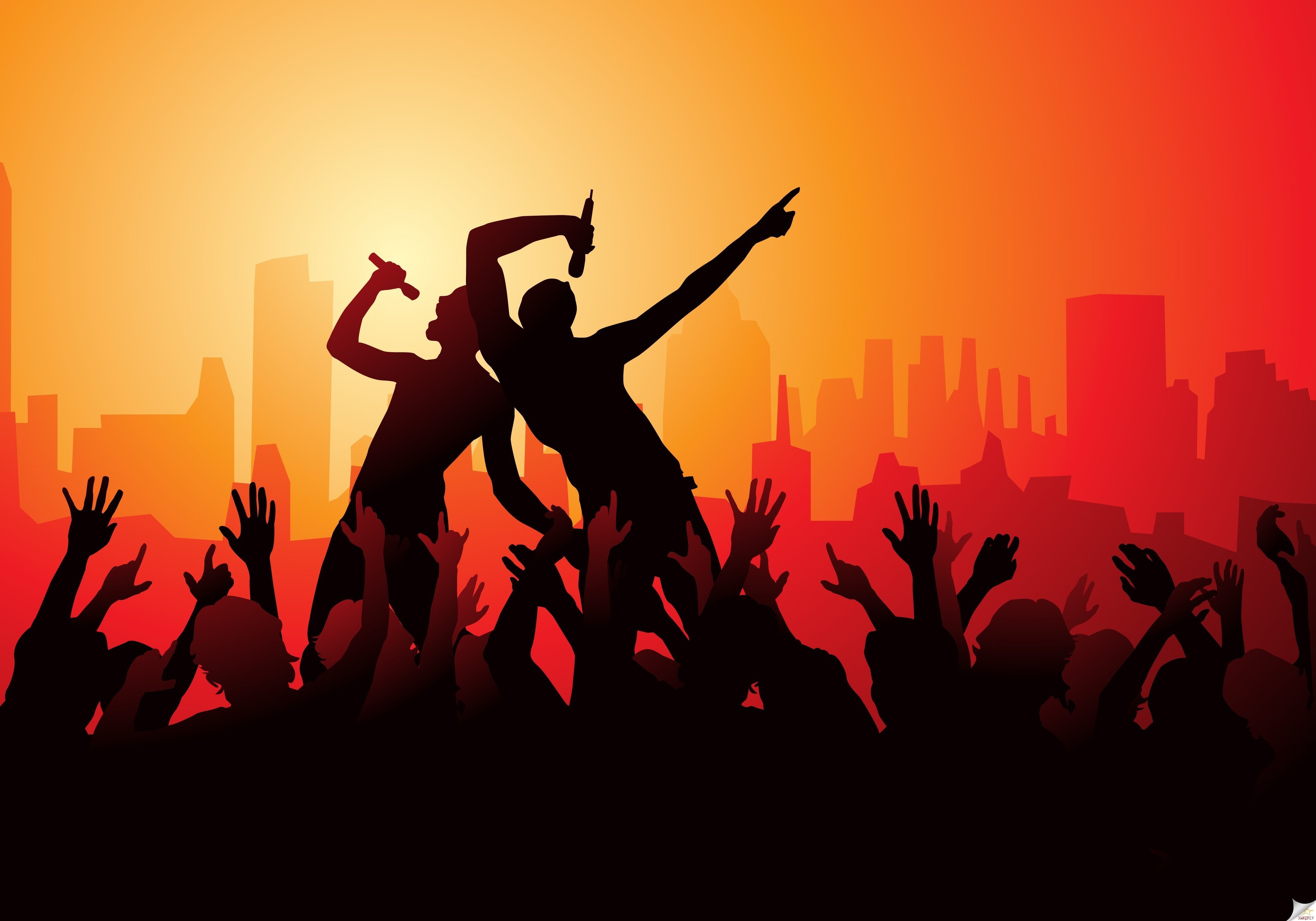 Singers performing in front of a city skyline at sunset HD Wallpaper