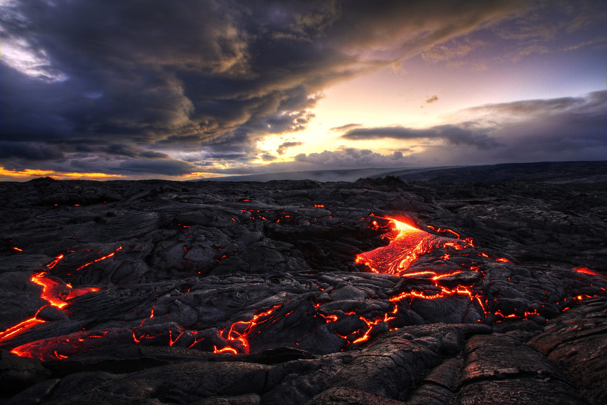 Molten Lava Flowing Across Rocky Landscape at Sunset in Indonesia HD Wallpaper