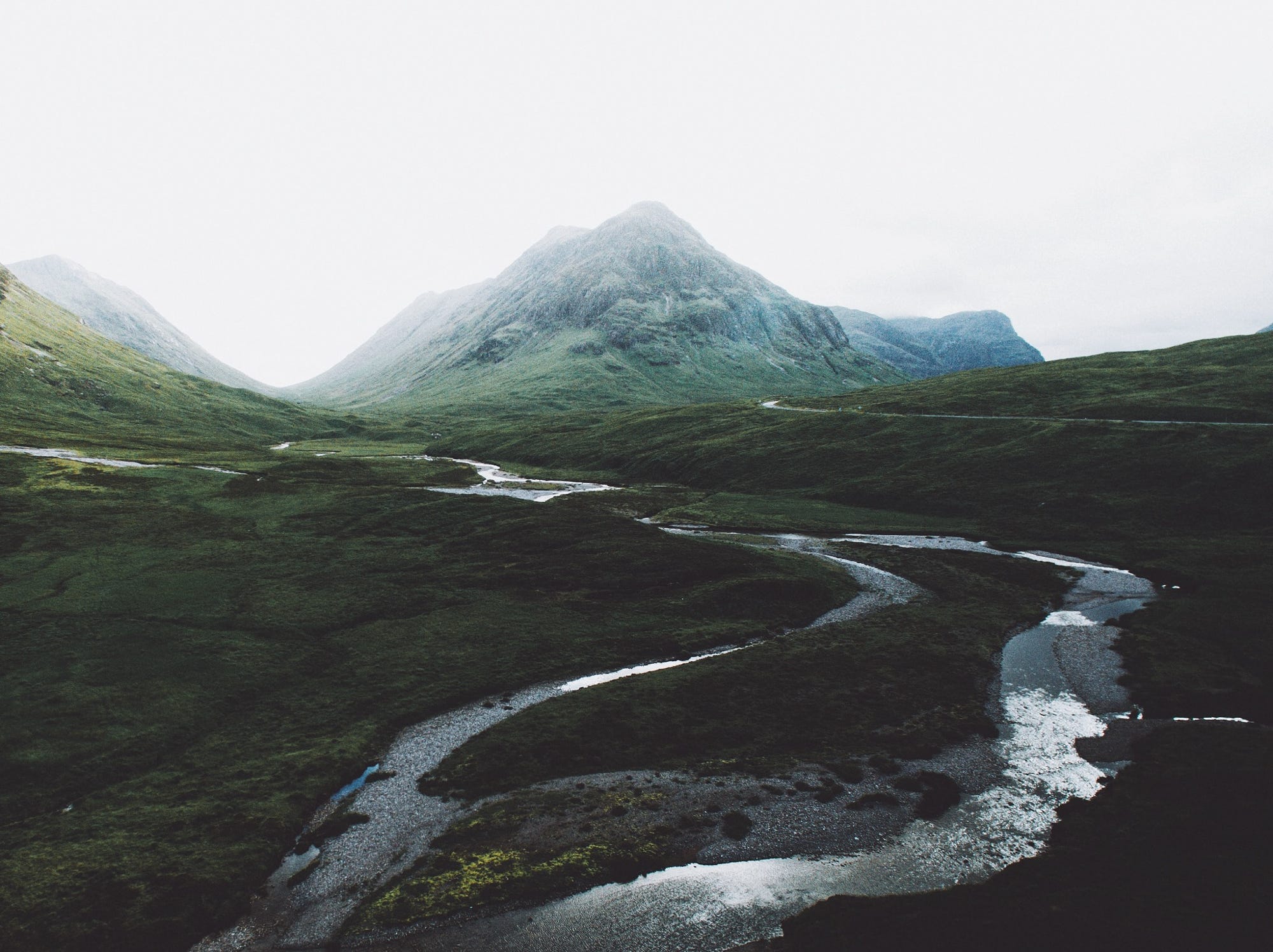 Mountain valley with winding river and road HD Wallpaper