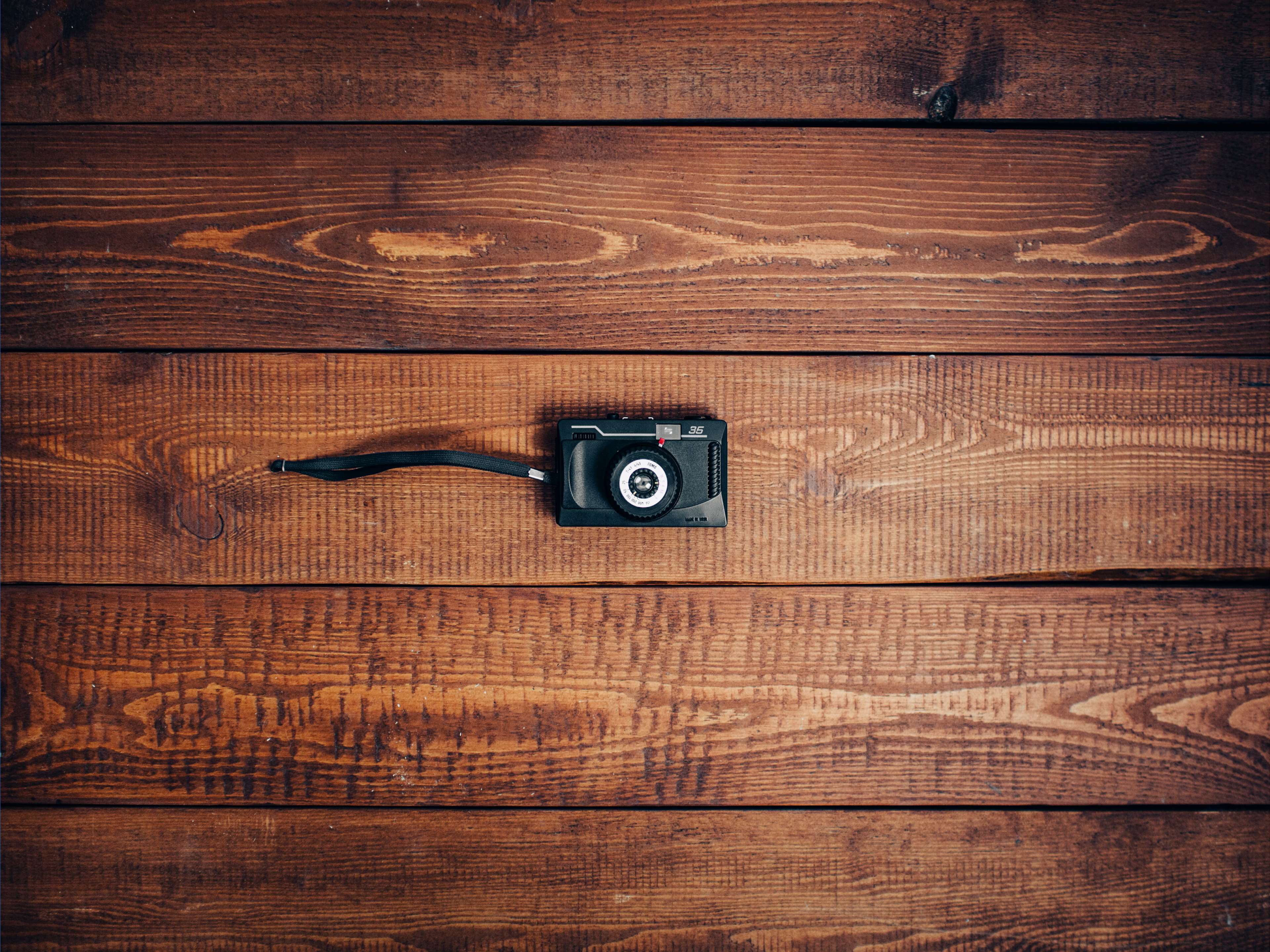 Vintage camera on a wooden board HD Wallpaper