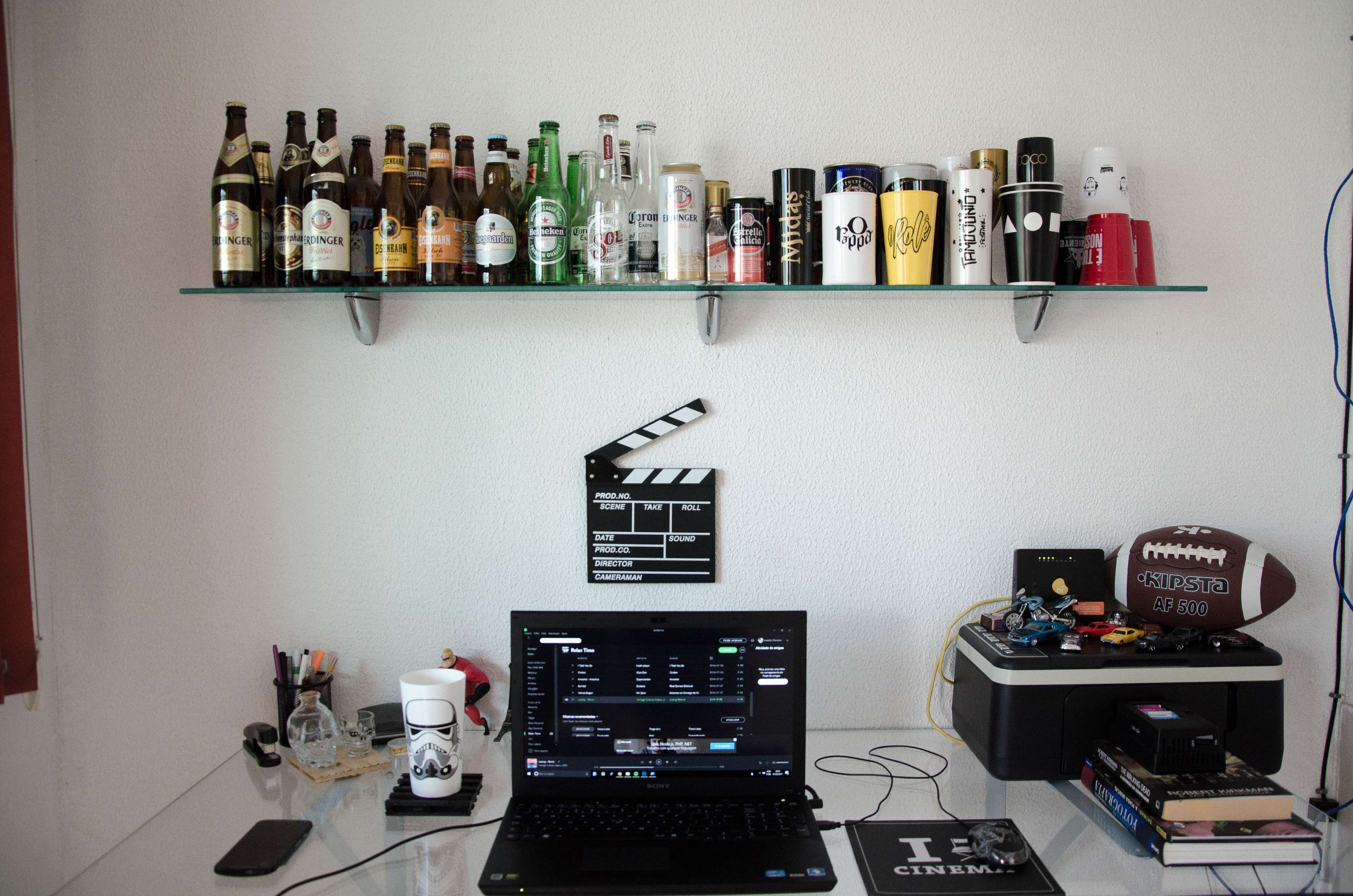 Home office with laptop and shelf of drinks HD Wallpaper