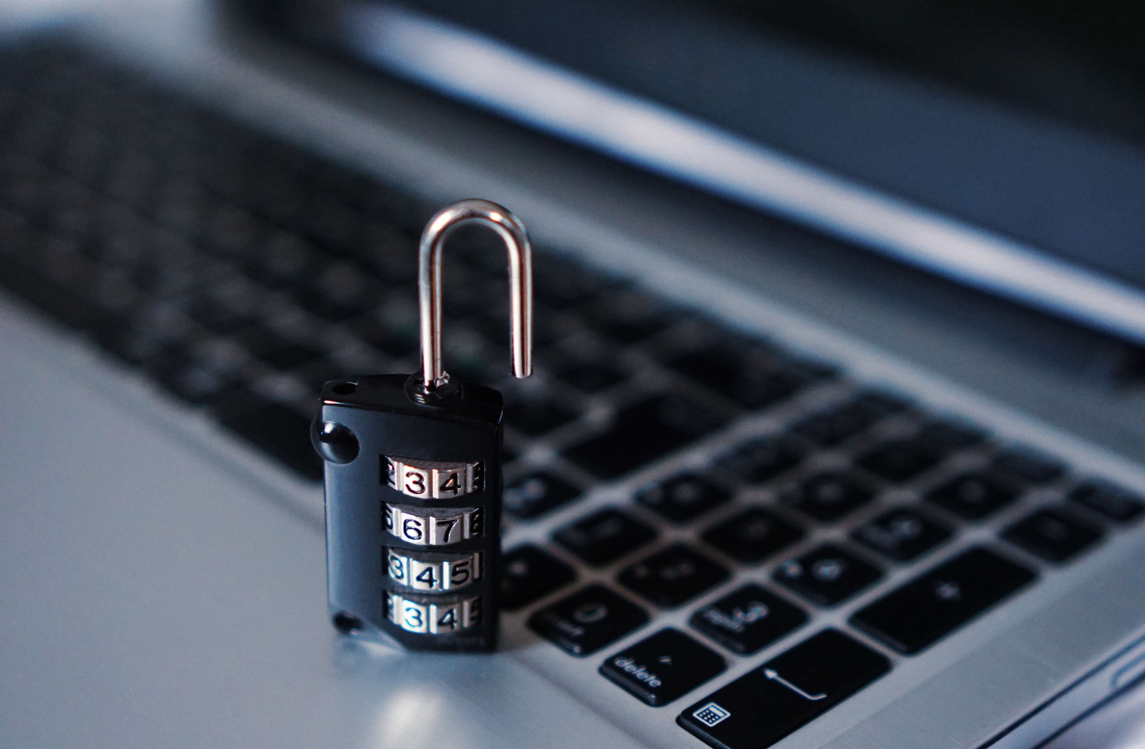 Combination padlock on a laptop keyboard HD Wallpaper