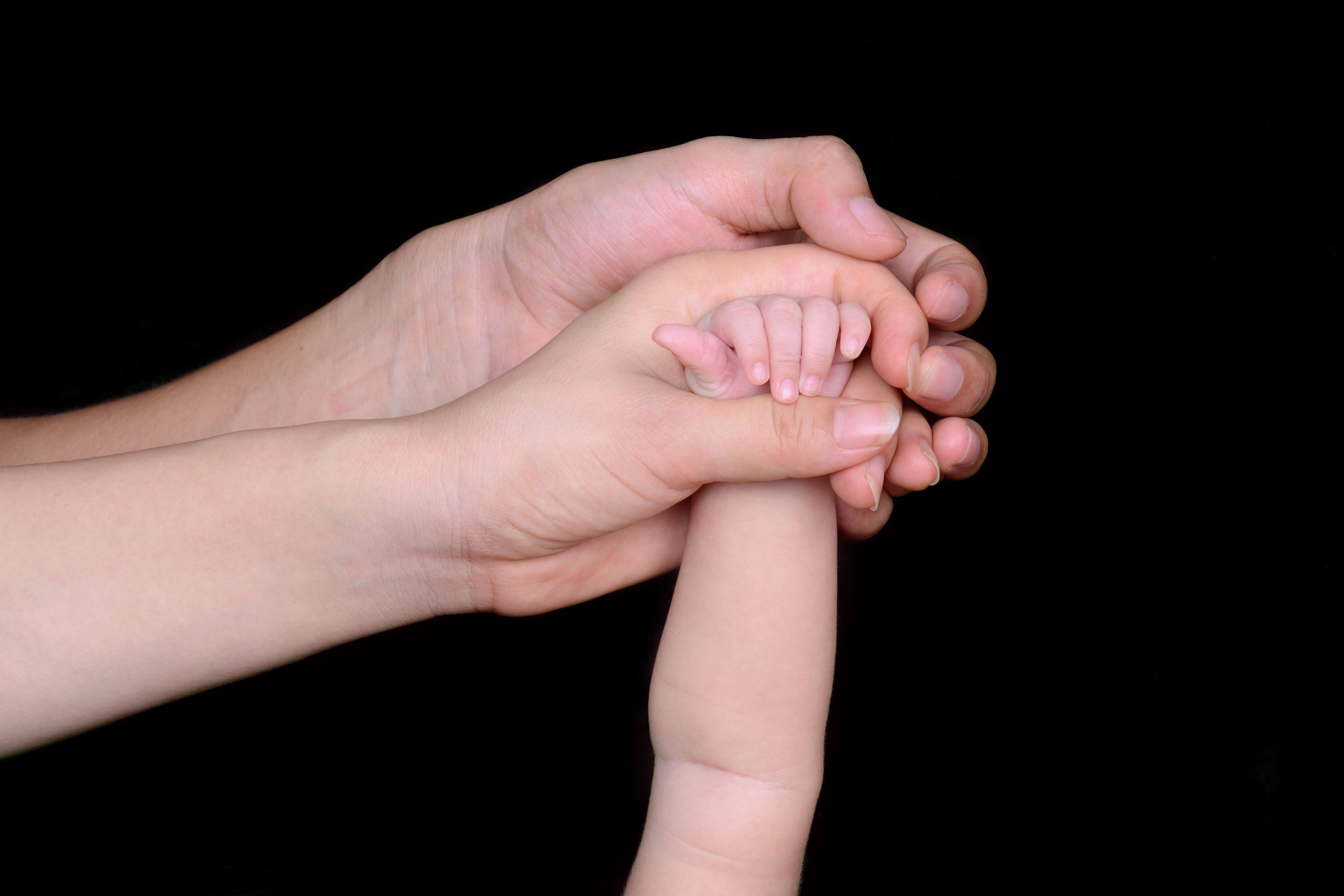 Adults holding a baby's hand HD Wallpaper