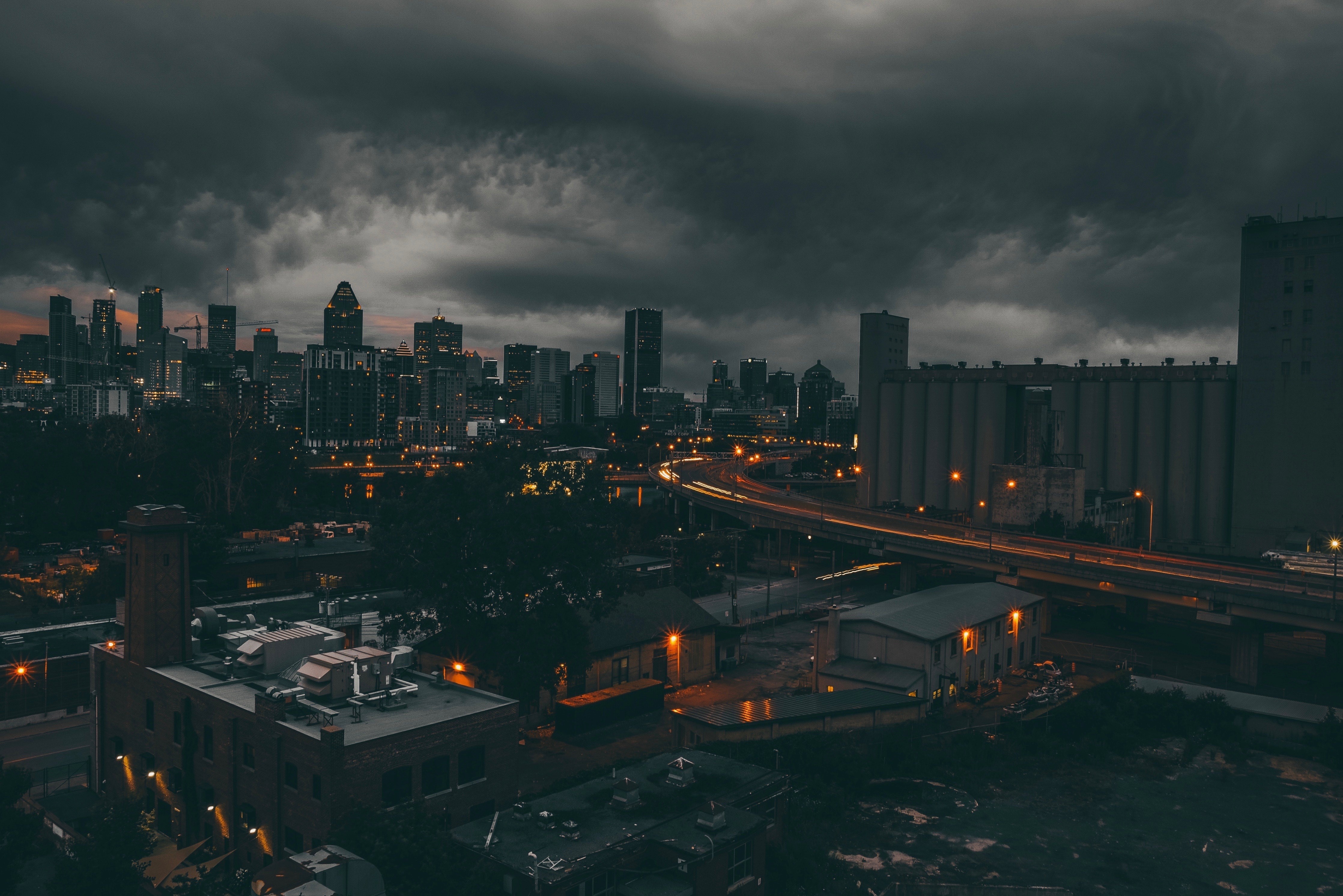 Montreal cityscape at night under stormy clouds HD Wallpaper