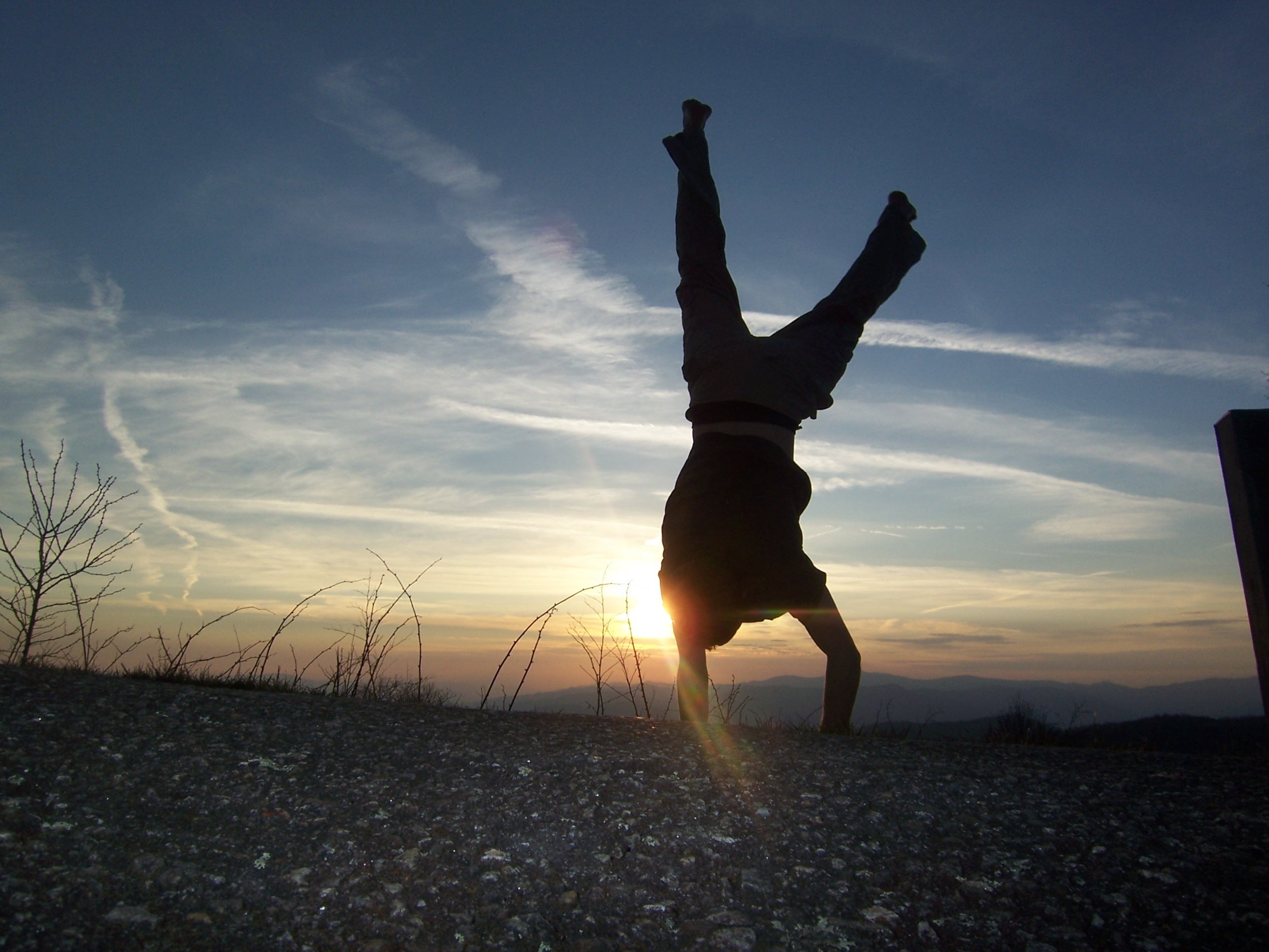 Person doing a handstand at sunset HD Wallpaper