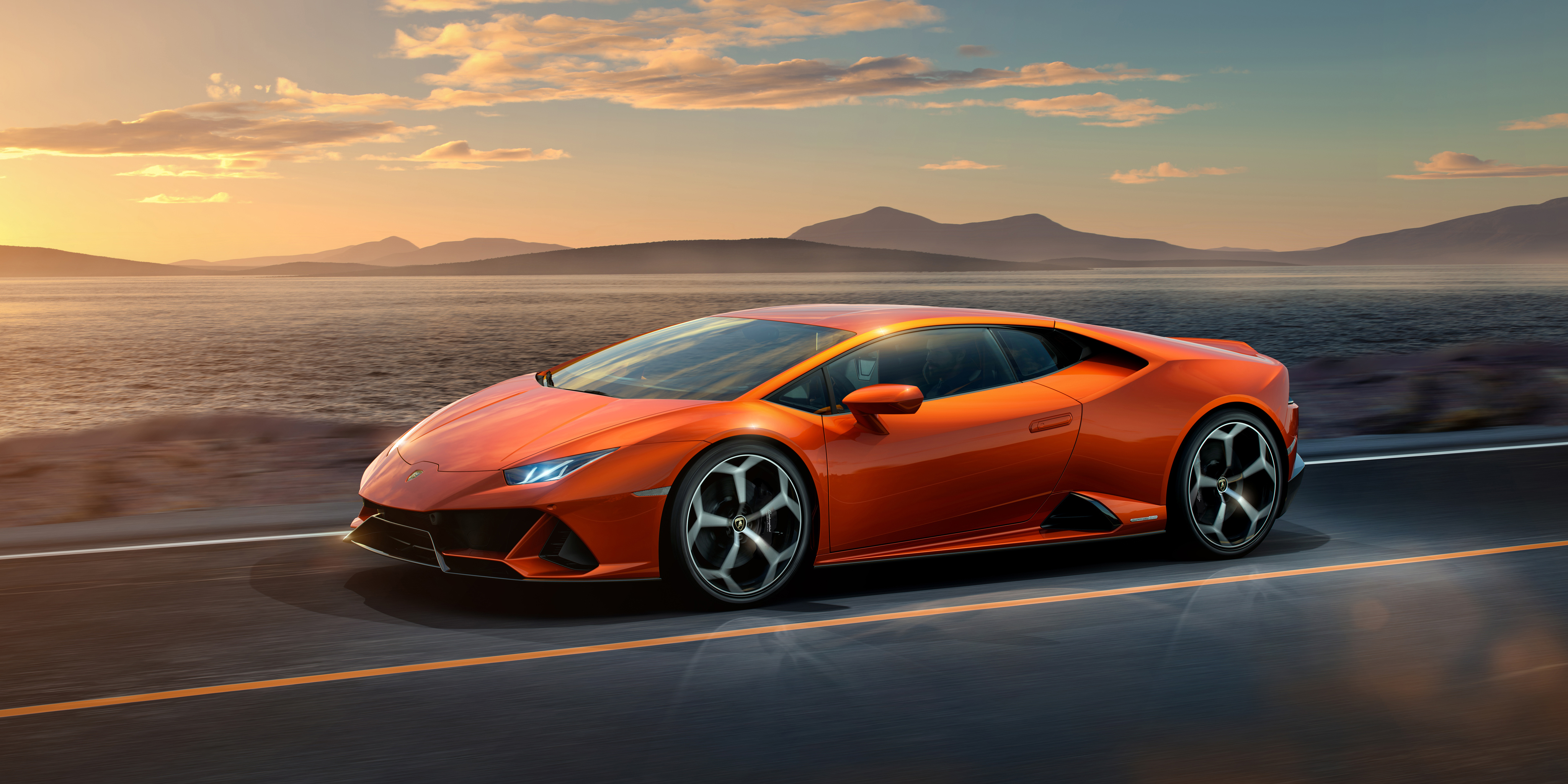 Orange Lamborghini Huracan Evo driving on road HD Wallpaper