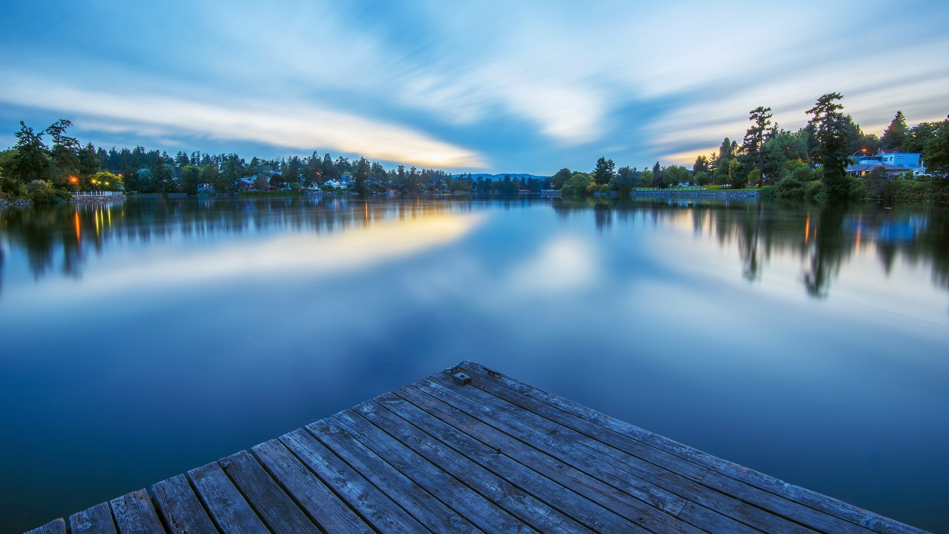 Wooden dock on a calm lake at dusk HD Wallpaper