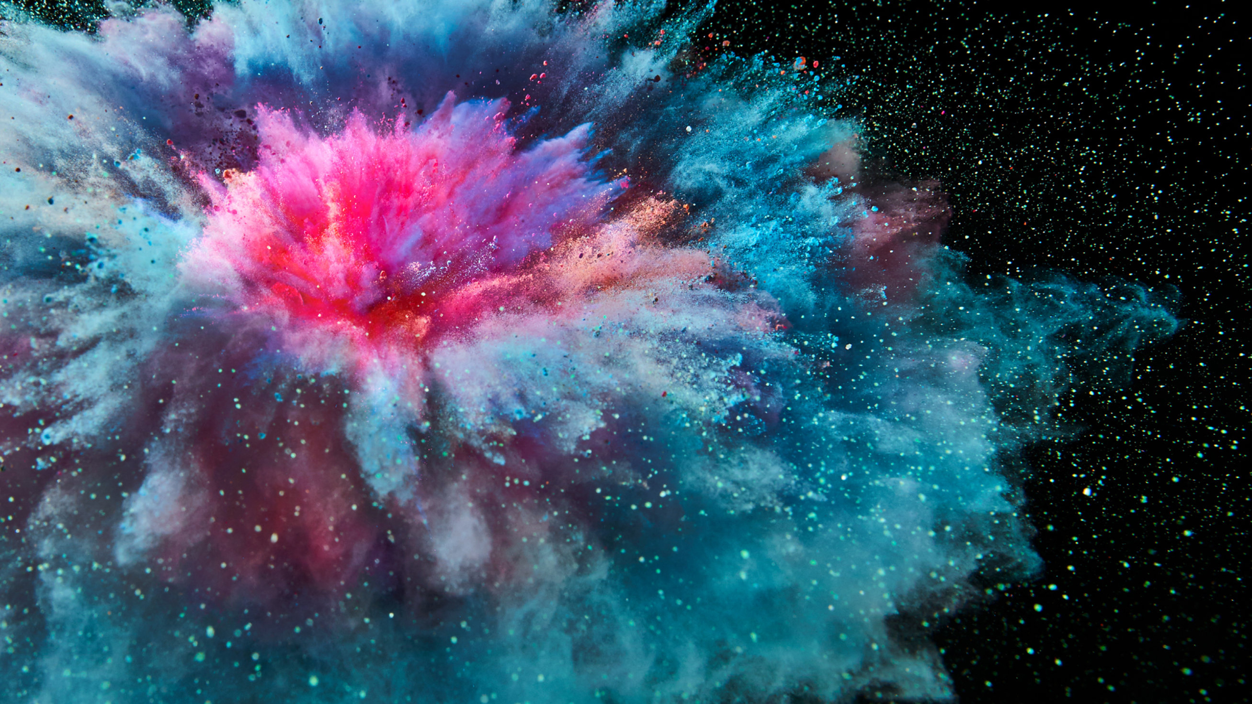 Explosion of colorful powder against a black background HD Wallpaper
