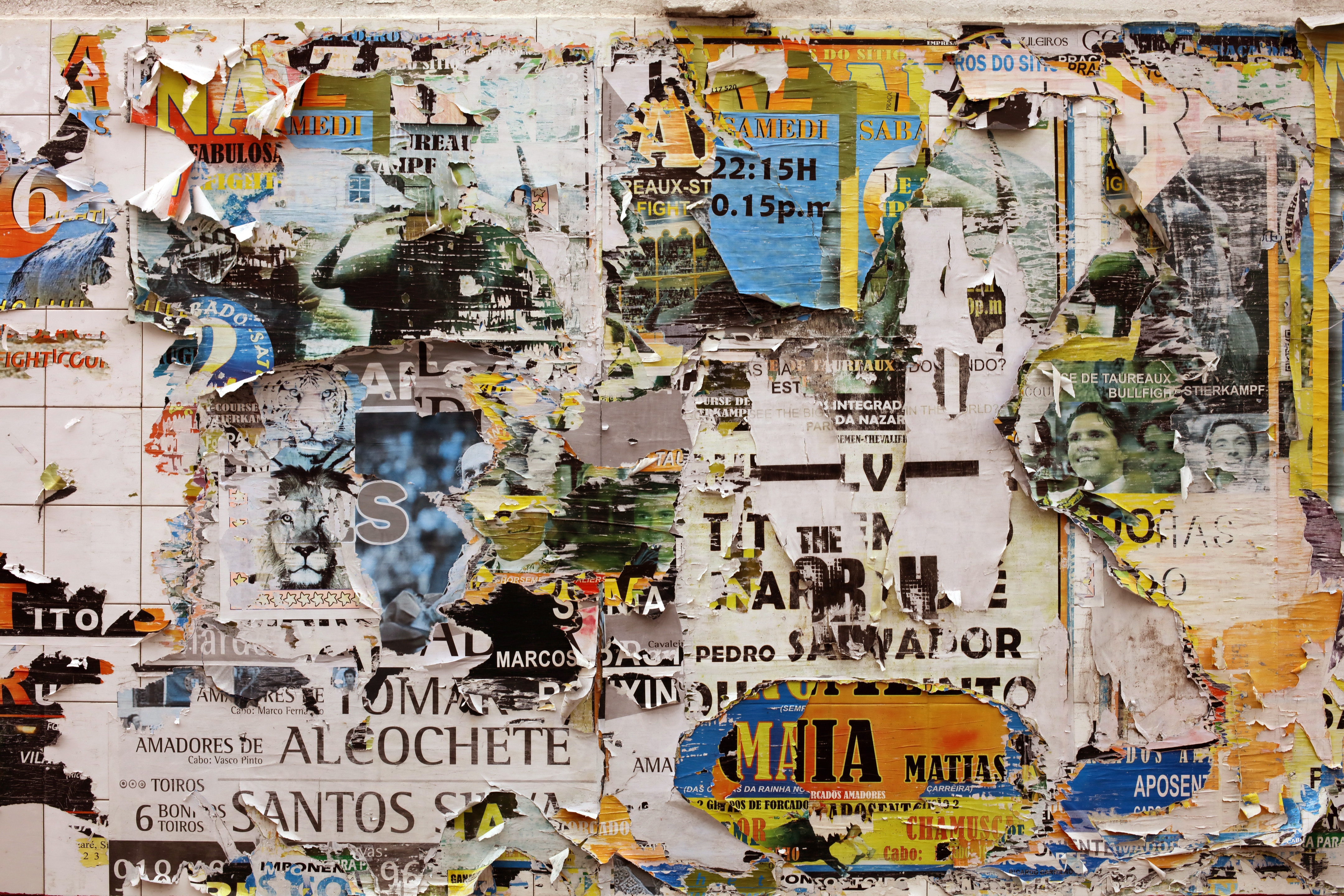 Torn posters on a tiled wall in Portugal HD Wallpaper