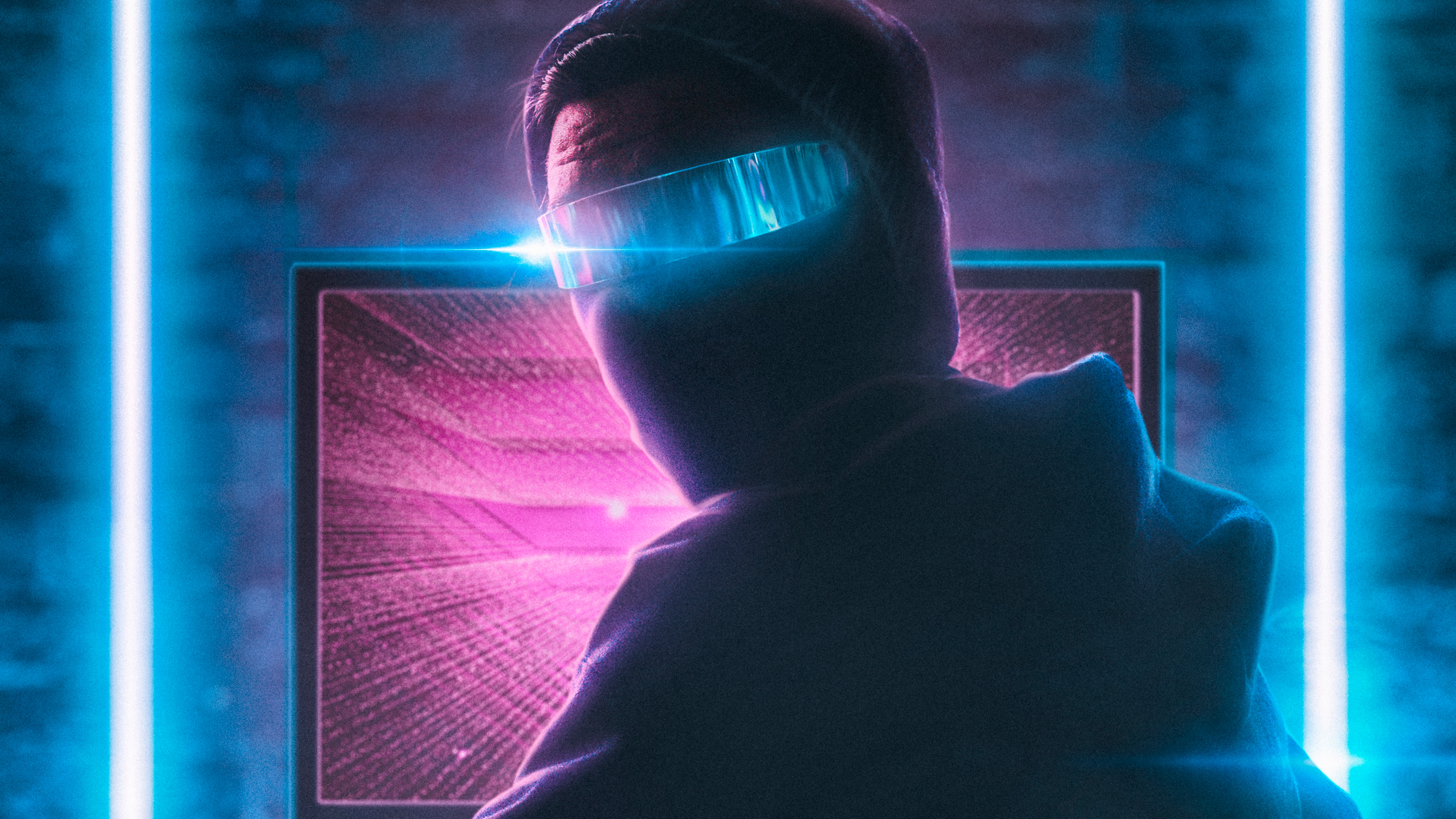 Hacker wearing futuristic glasses in front of a computer HD Wallpaper