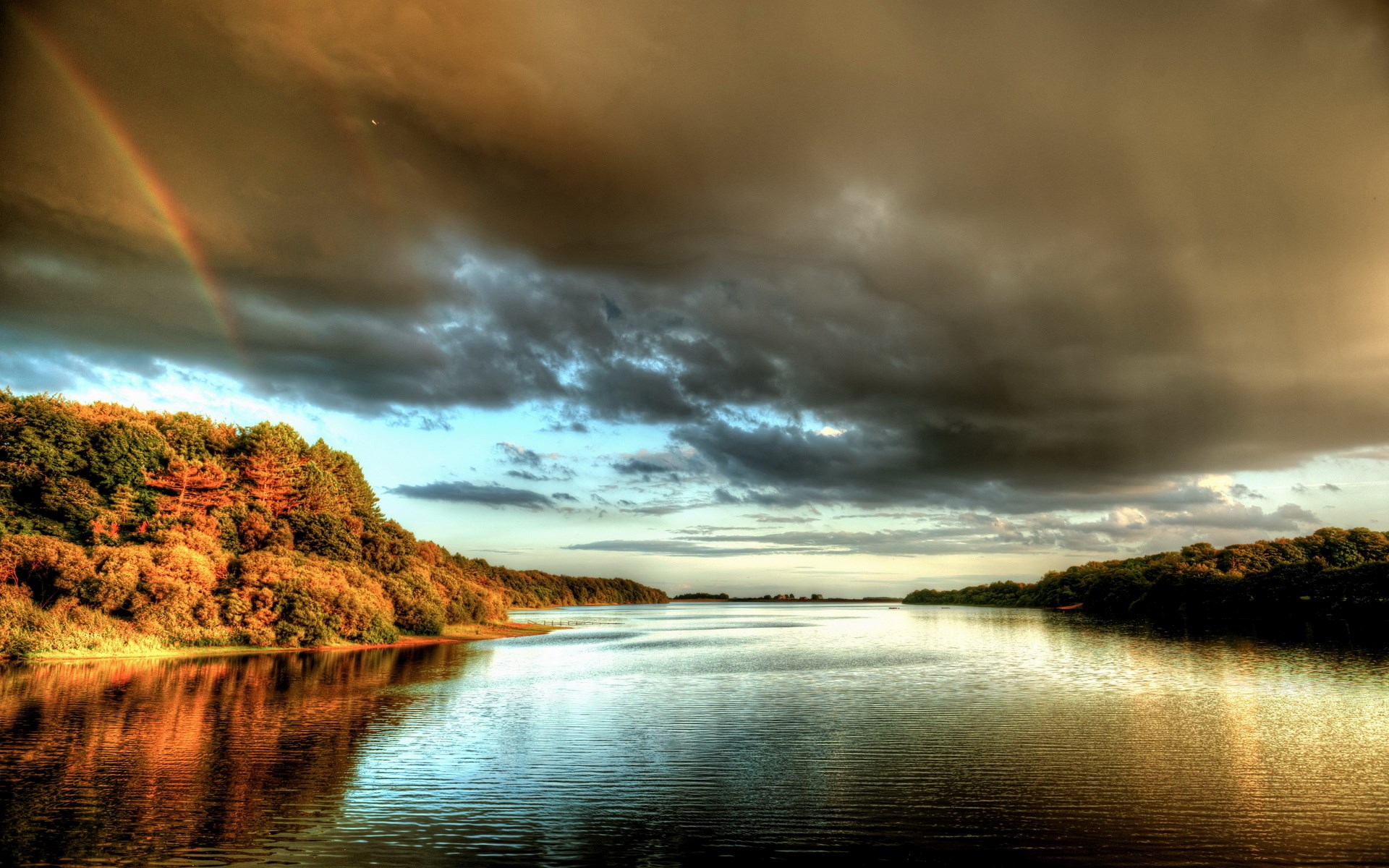 Rainbow over a lake with trees and stormy clouds HD Wallpaper