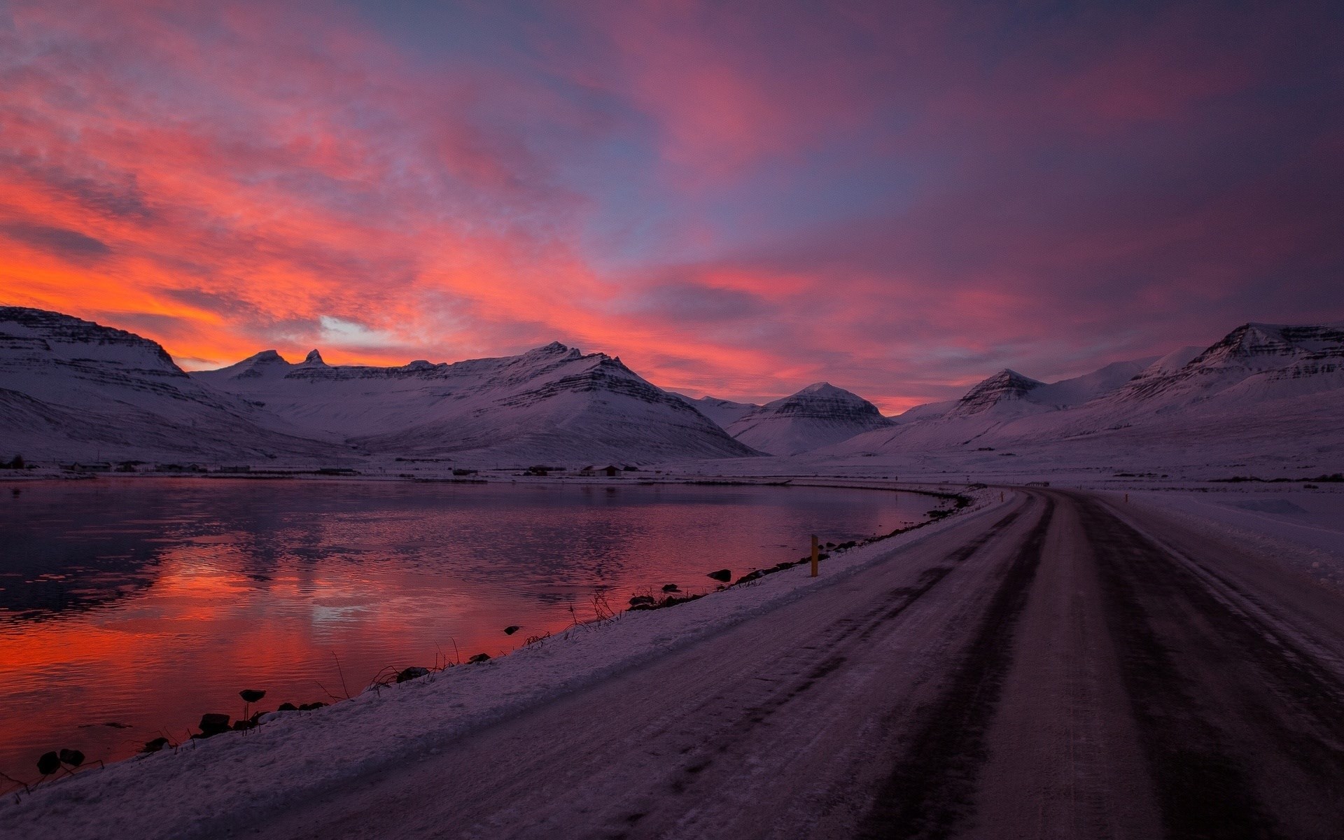 Snowy mountains and a road at sunset HD Wallpaper